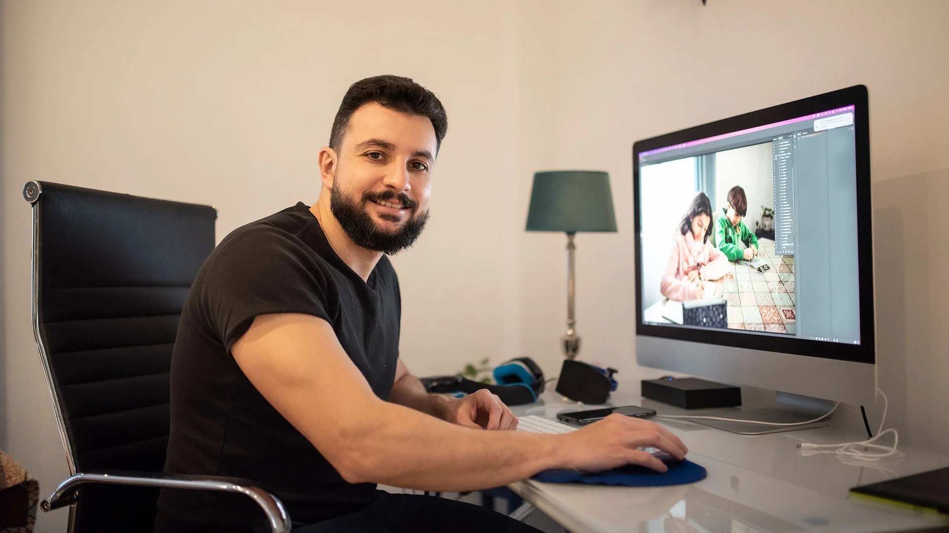 Man editing photos on his laptop as part of his freelance photography job.