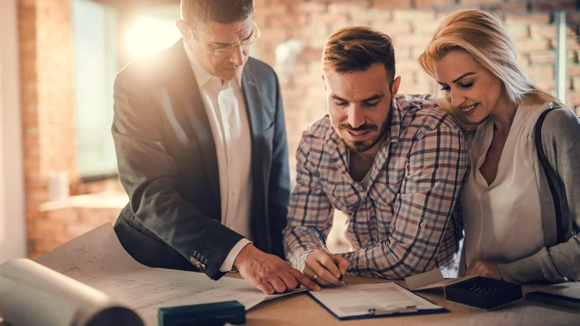 A couple signing a sale and purchase agreement in New Zealand.