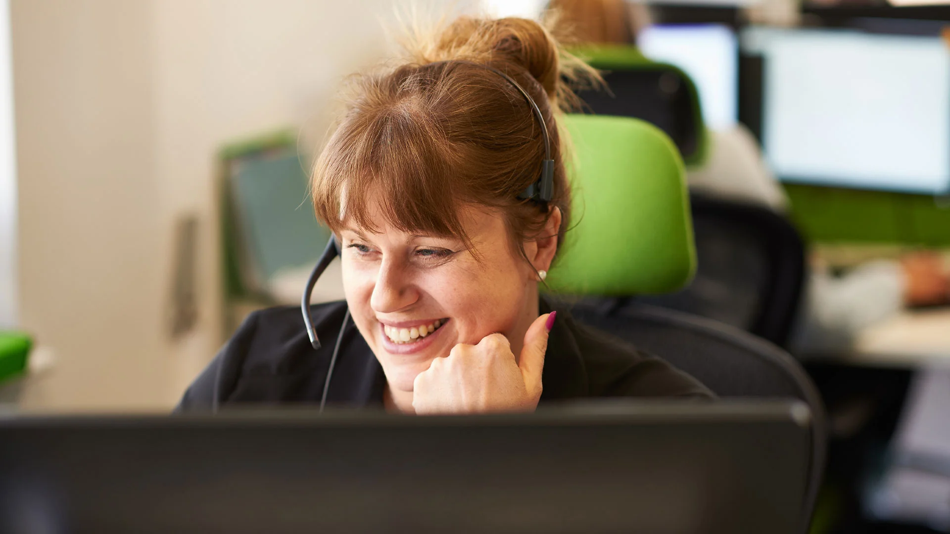 Customer service agent talking on her headset at work.