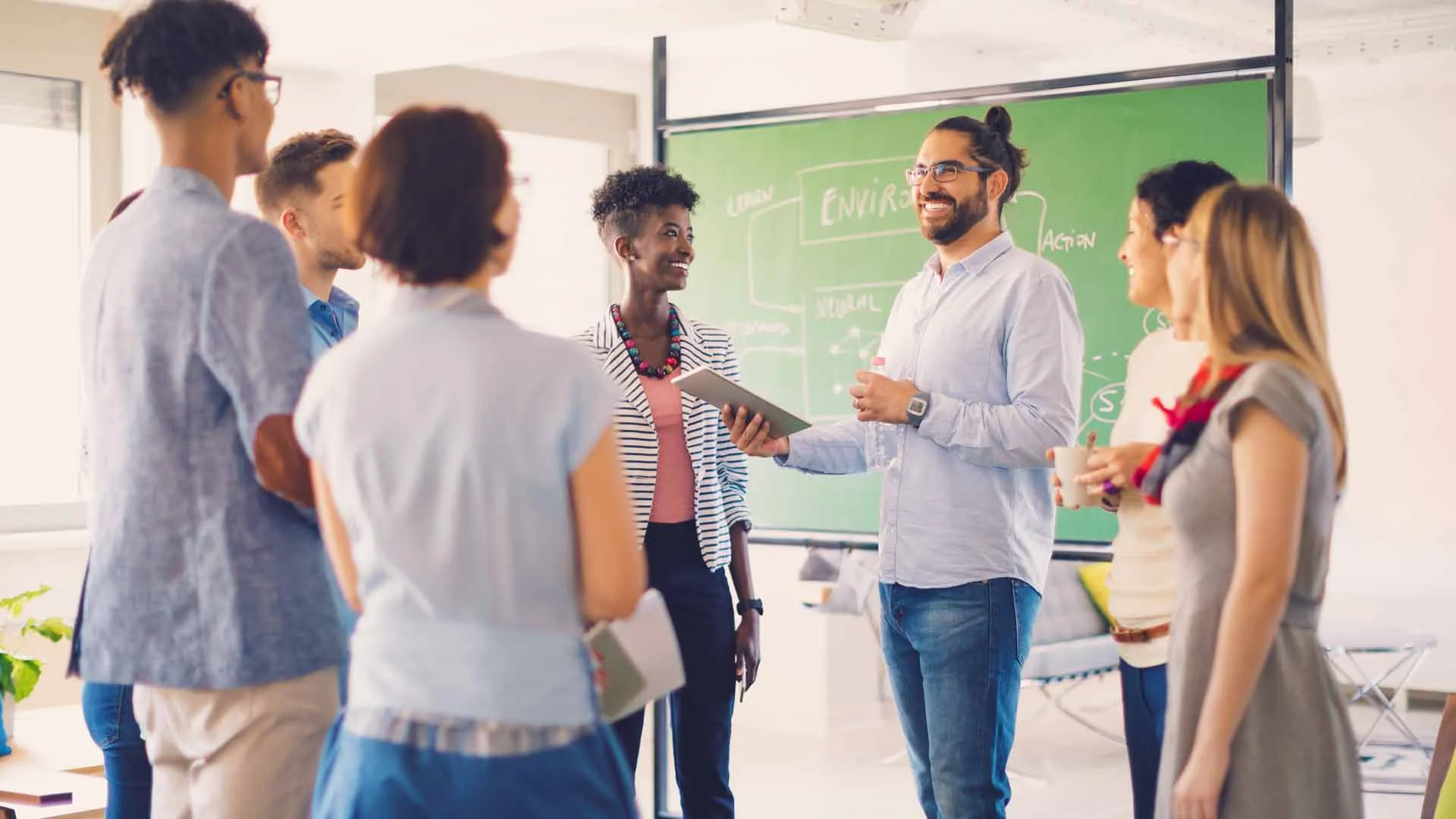 Workplace team having a morning planning meeting in an office.