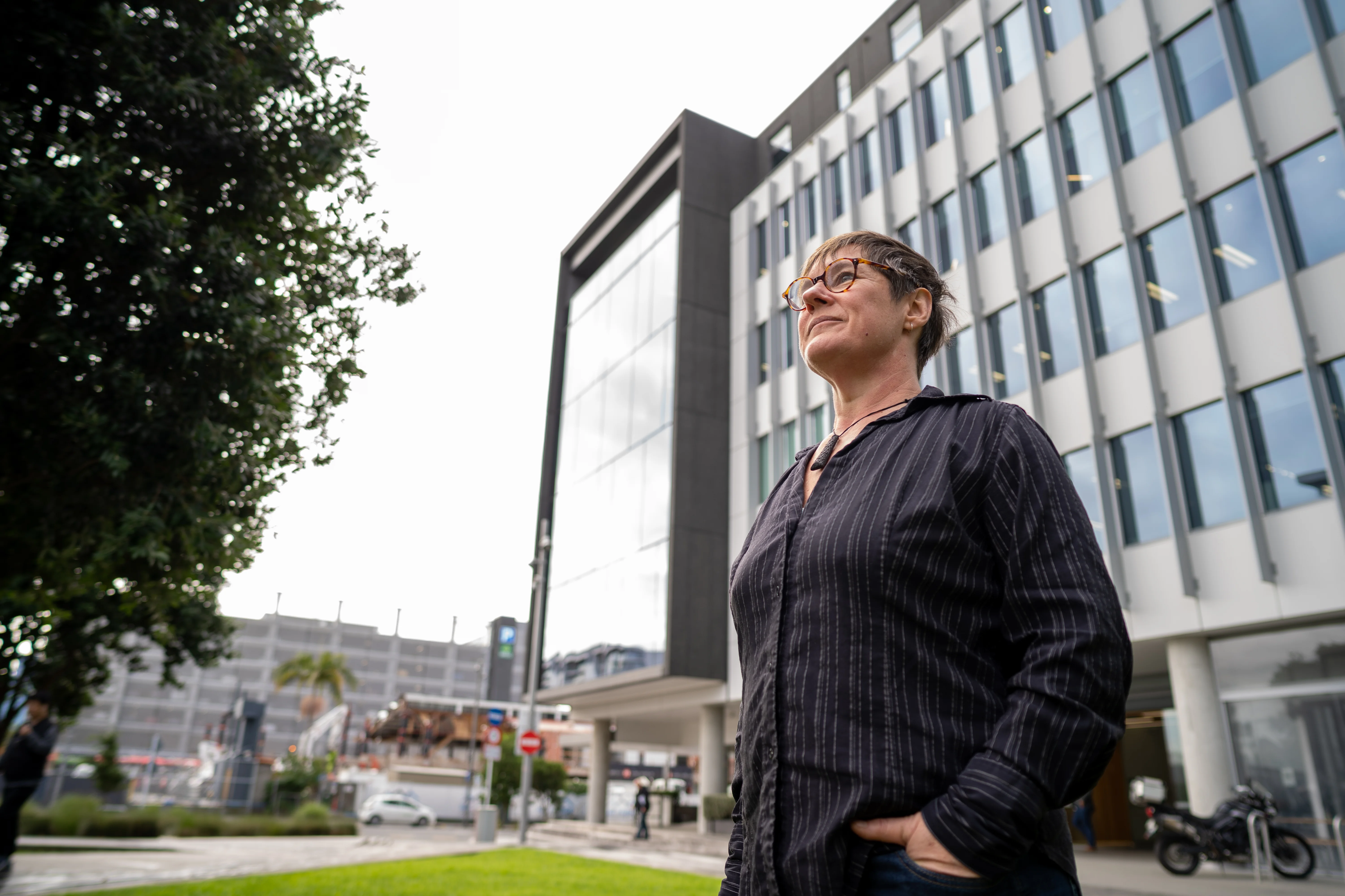 Woman standing amongst high rise buildings