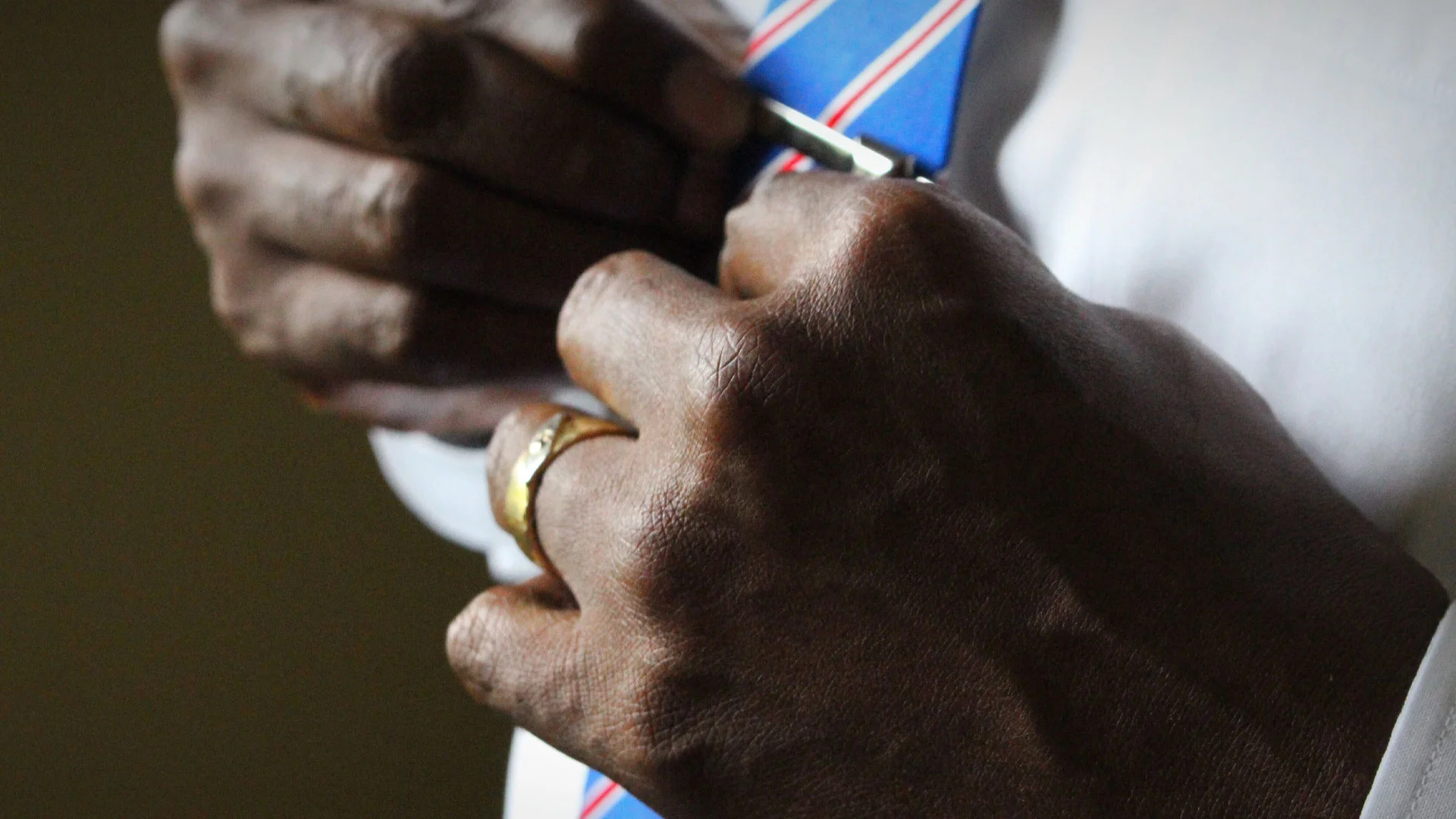 Man tying a tie ready for his first day at work.