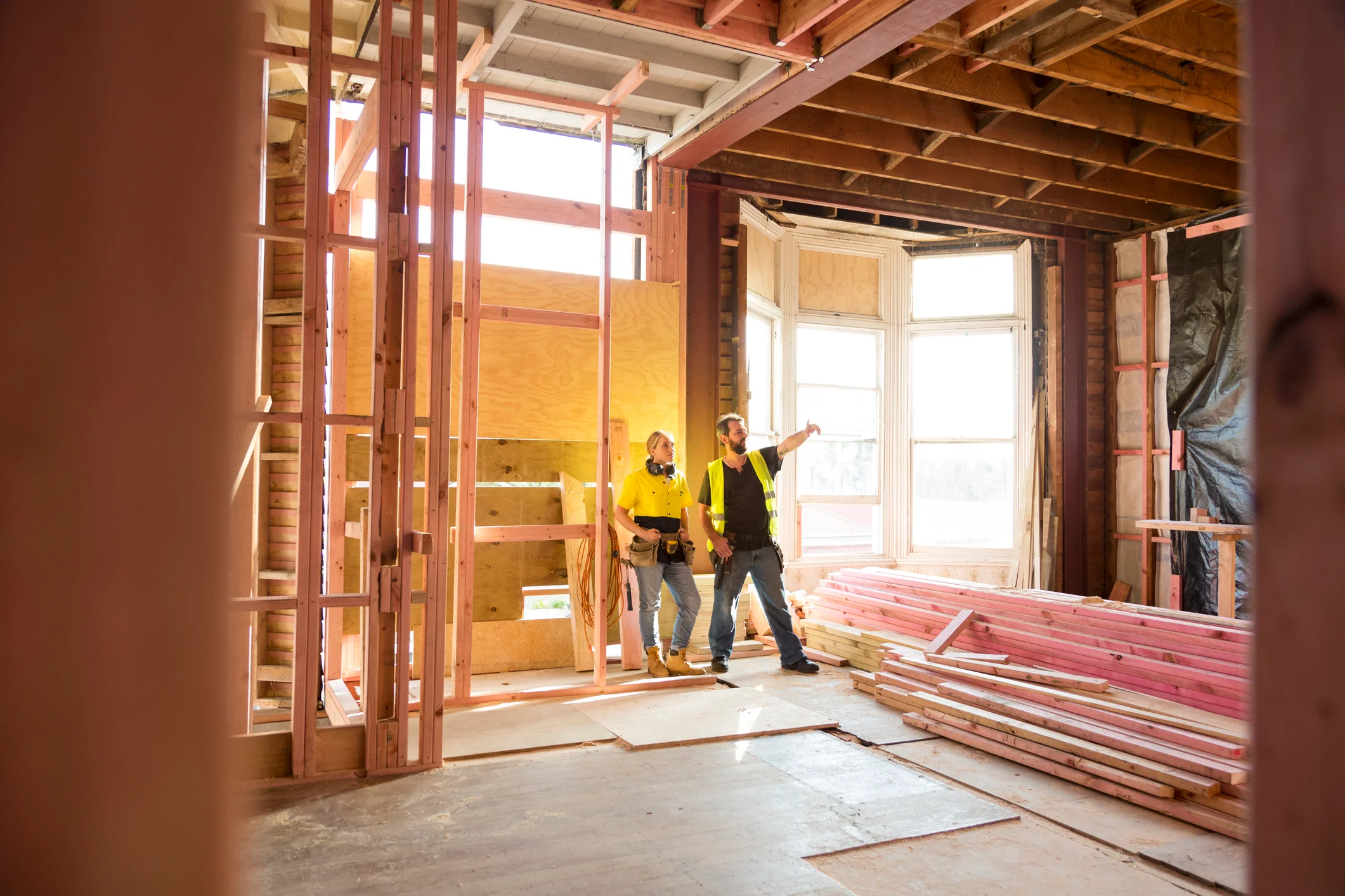 Two builders looking at house.