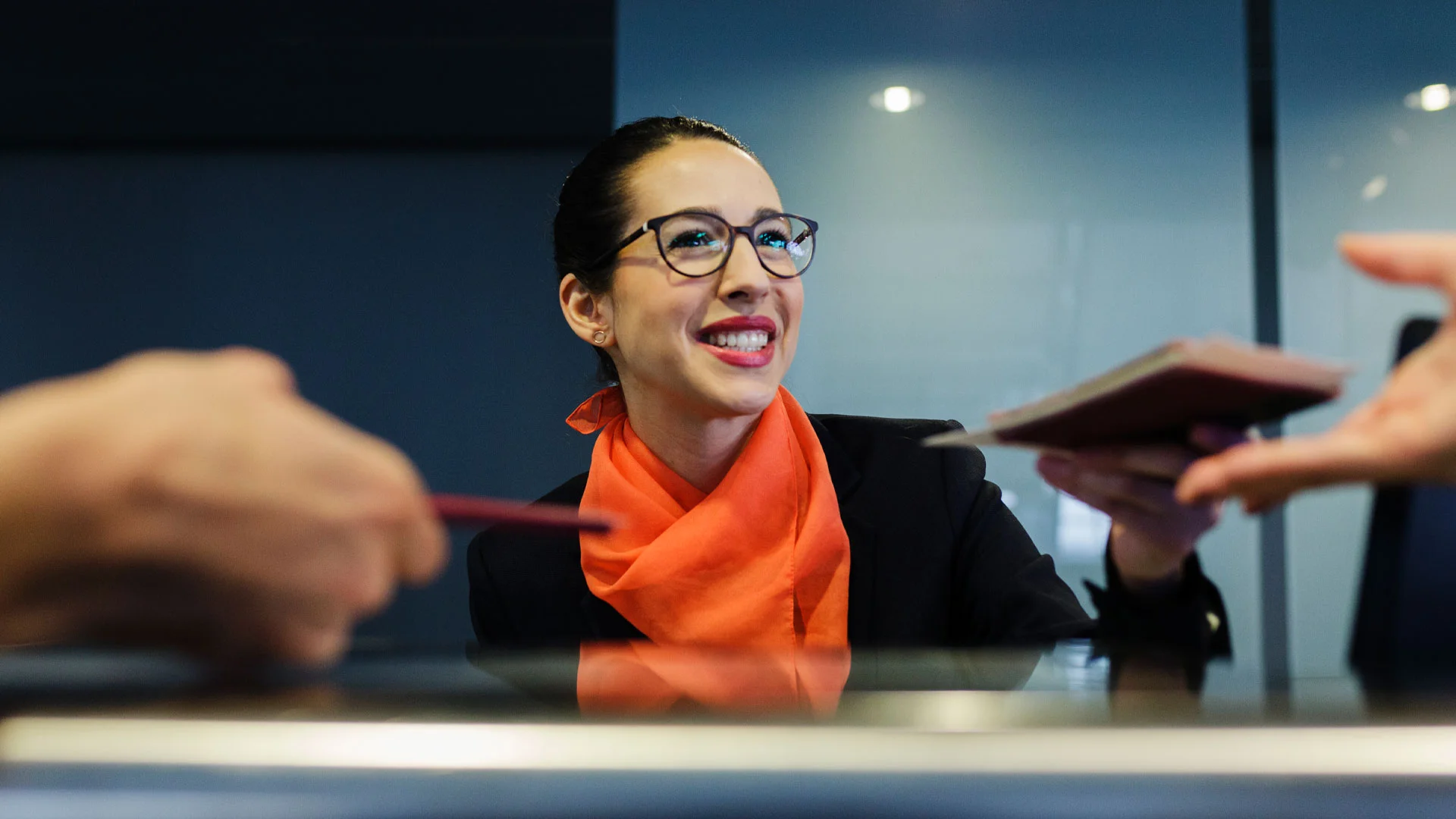 Airport worker at her job behind a desk in a New Zealand airport.