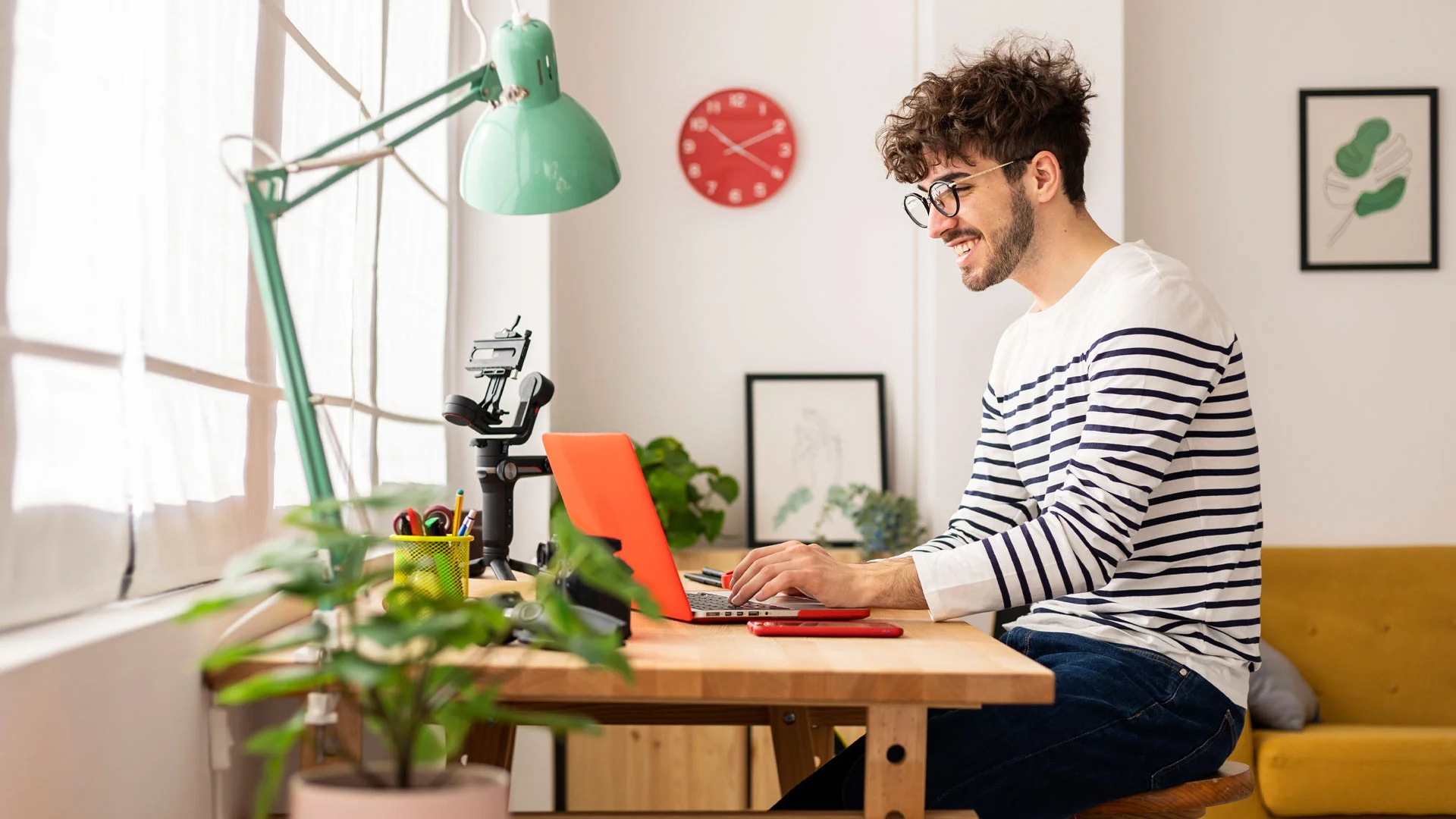 Young man writing a cover letter at home on a laptop.