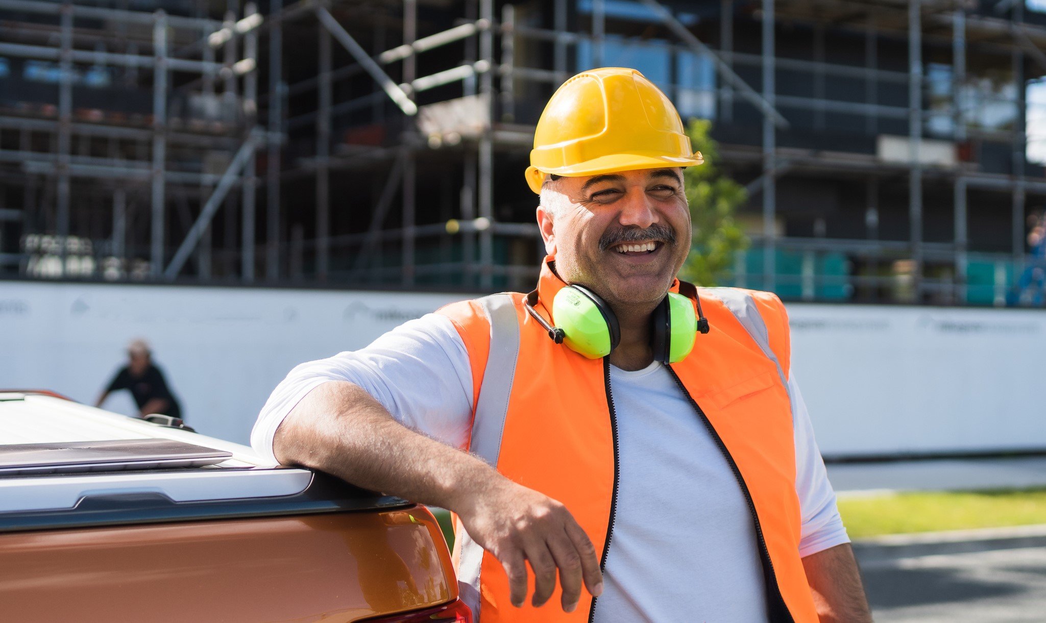 Construction Director standing in front of building site