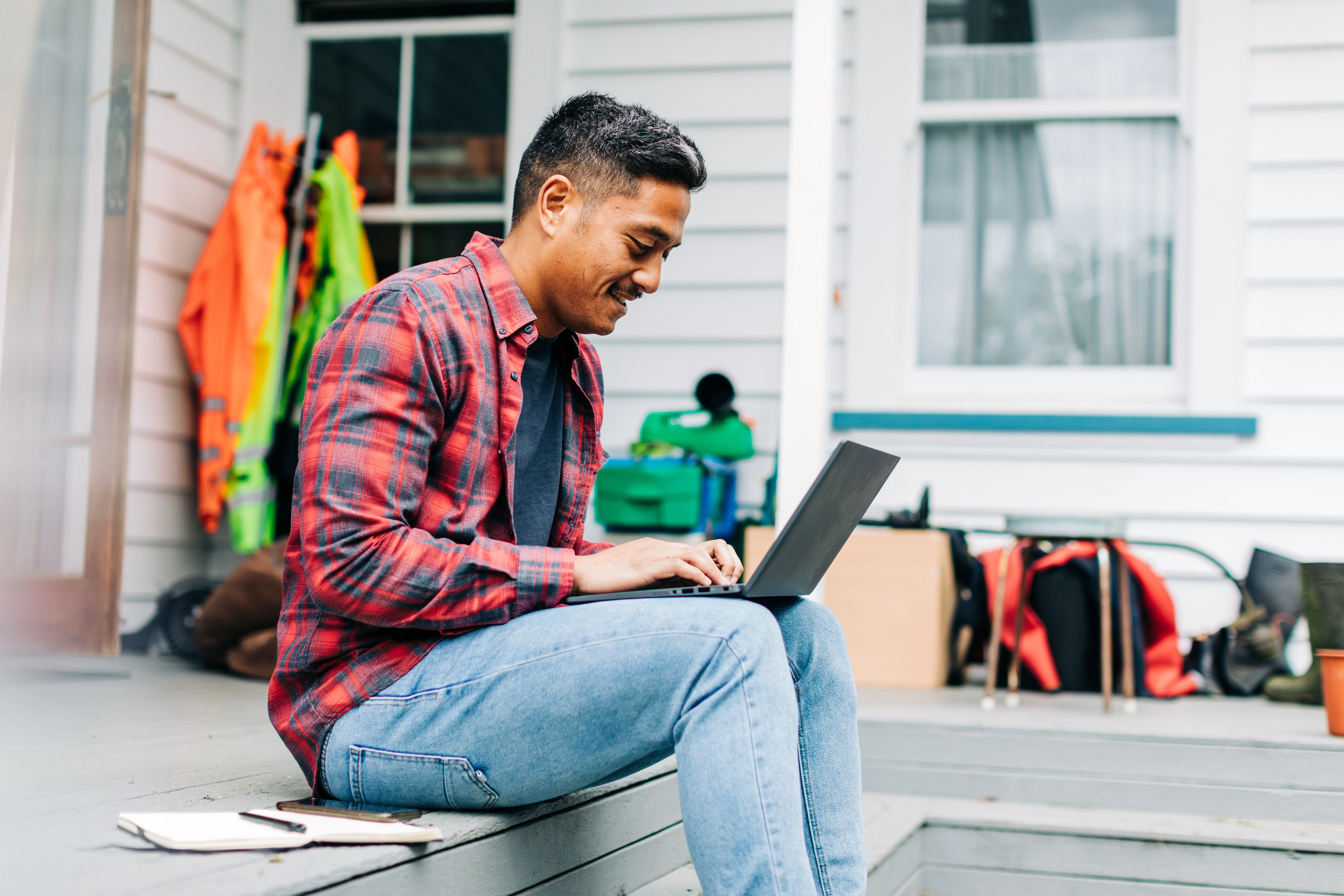 Man sitting outside with laptop