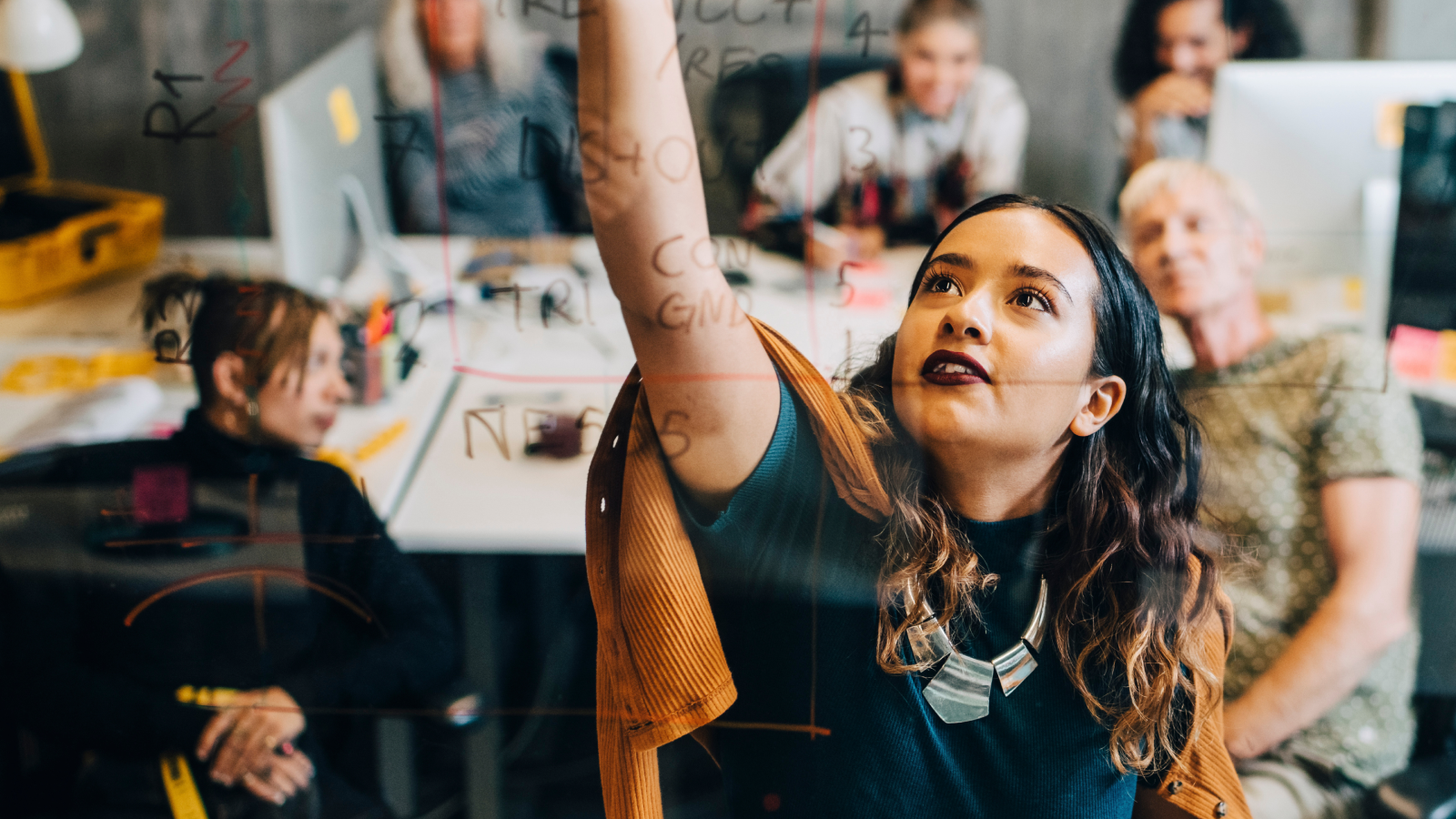 Woman writing on whiteboard