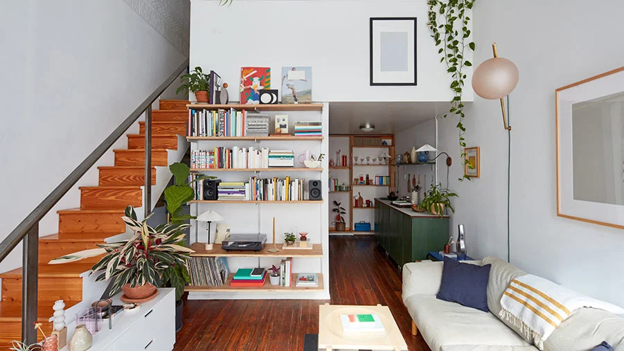 Cleverly organised home interior, with a space under the stairs being used as a laundry area.