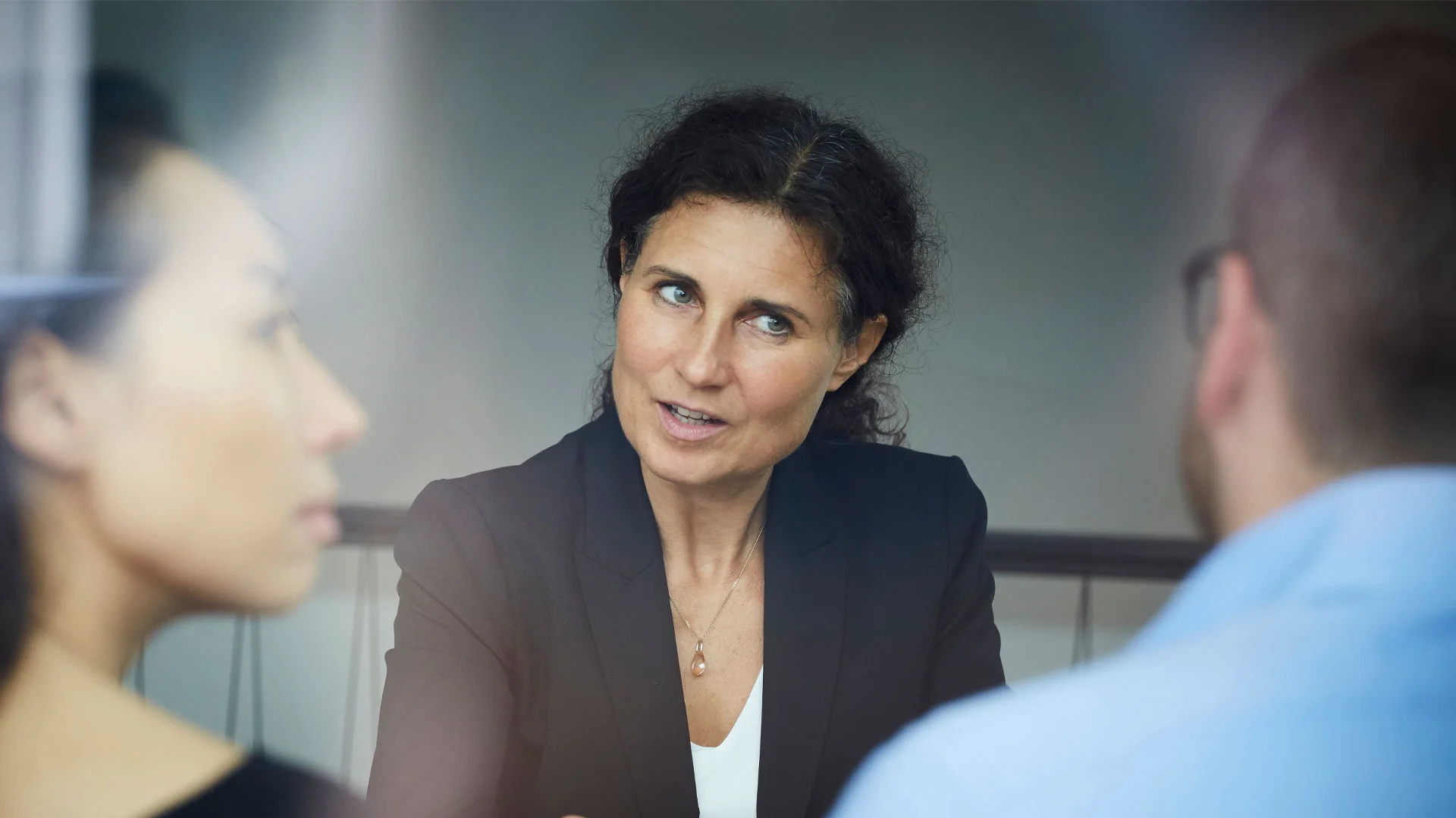 A lawyer talking to her clients about a home sale and purchase agreement.