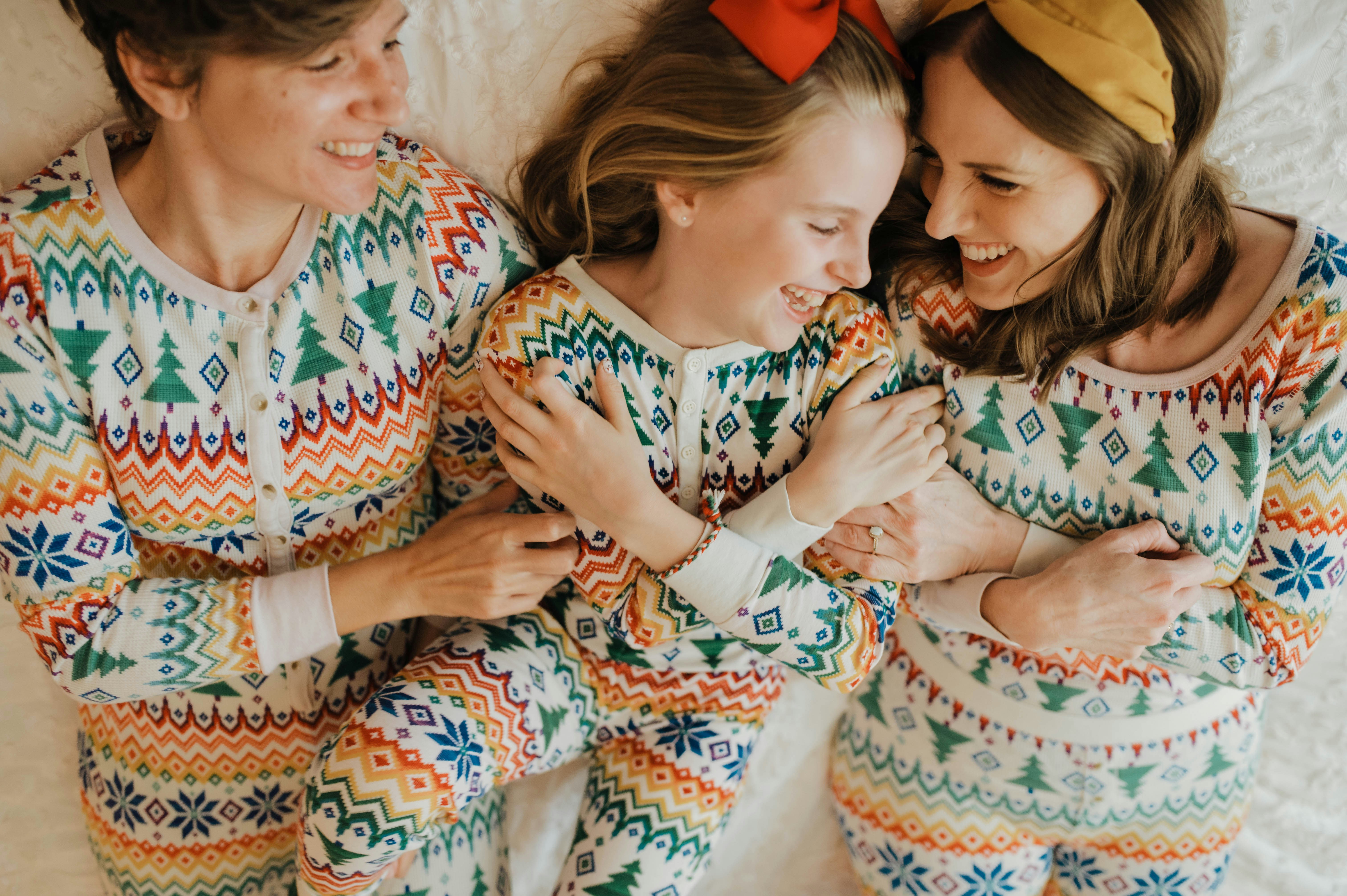 A mother, father, and child wearing matching pyjamas.