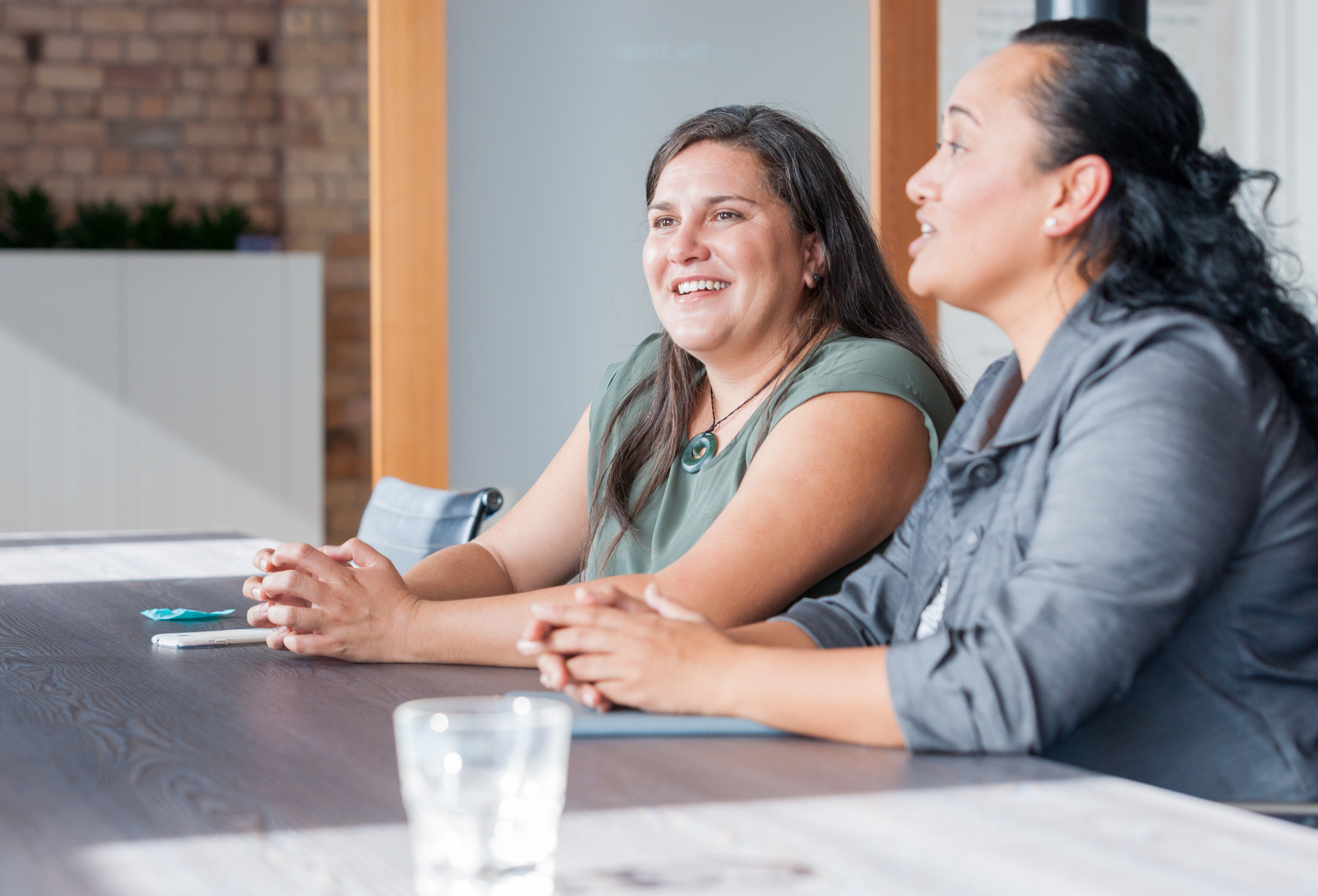 Two women talking in a meeting room