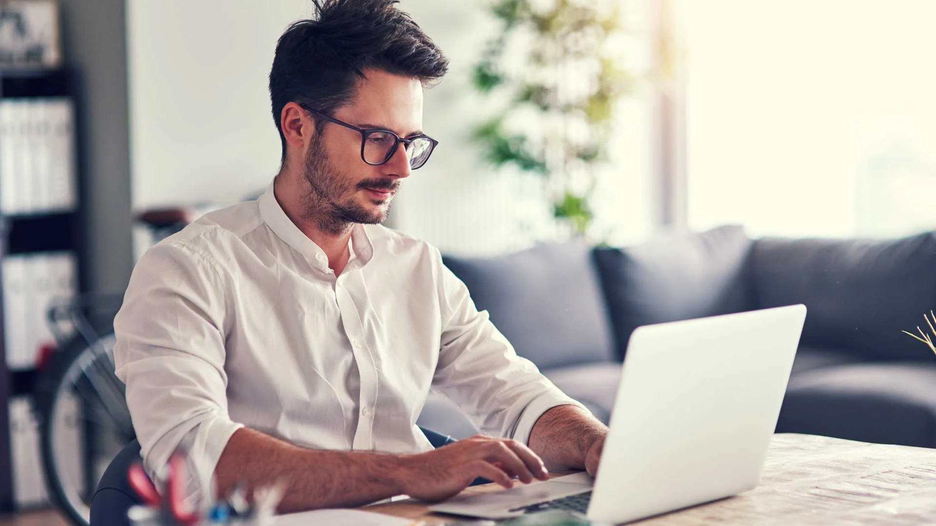 Young man testing his video conferencing setup at home.