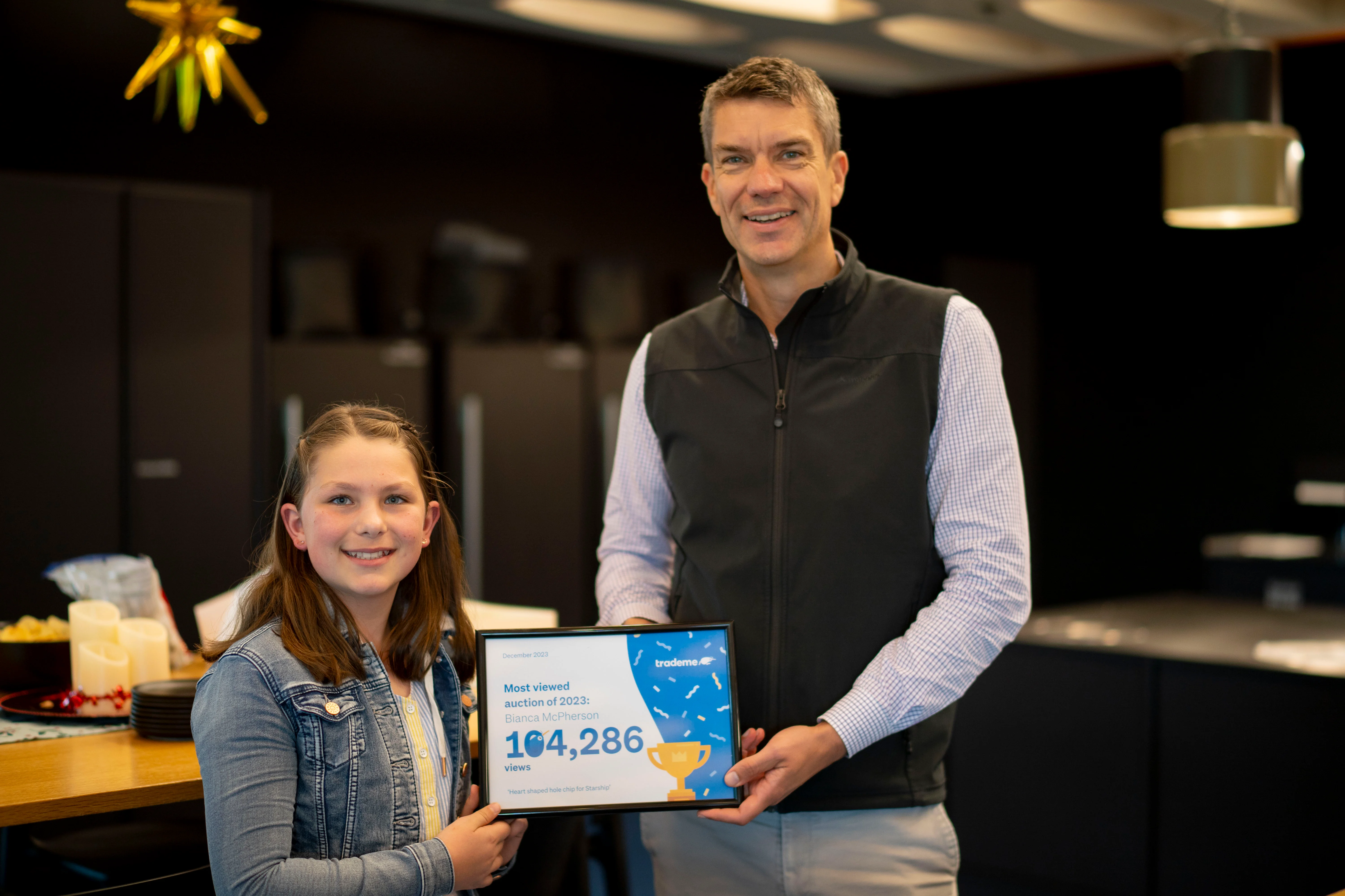 Young girl holding a chip with a hole in it shaped like a heart