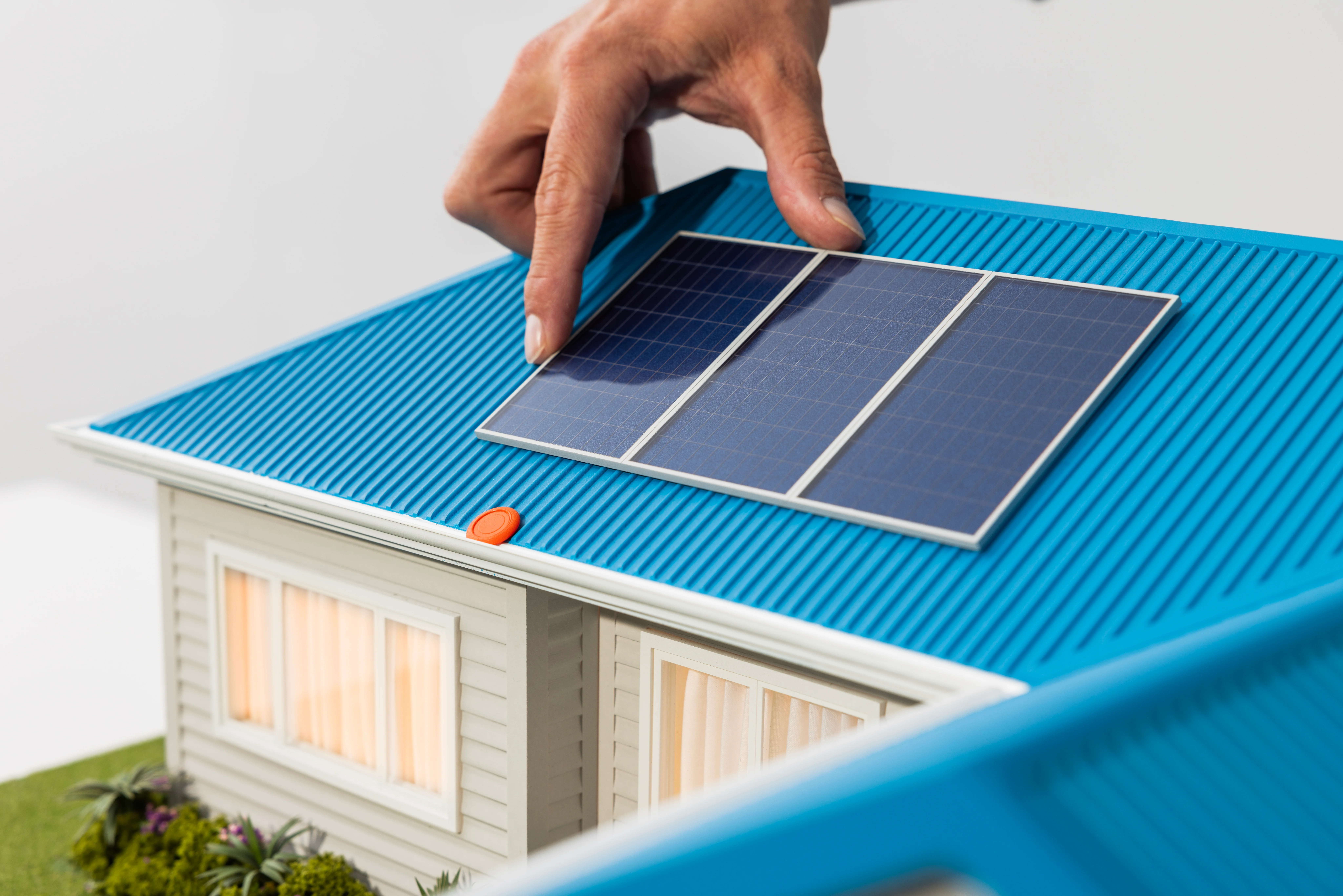 House touches solar panel on miniature home