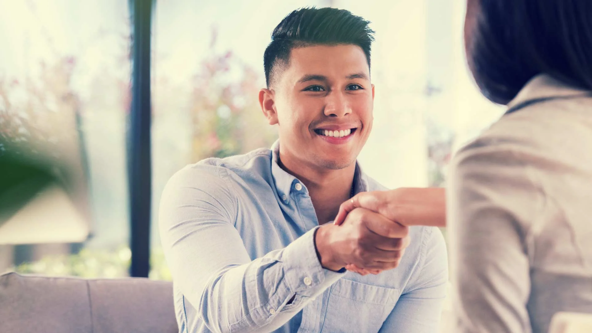 Job interviewer shaking hands with a candidate.