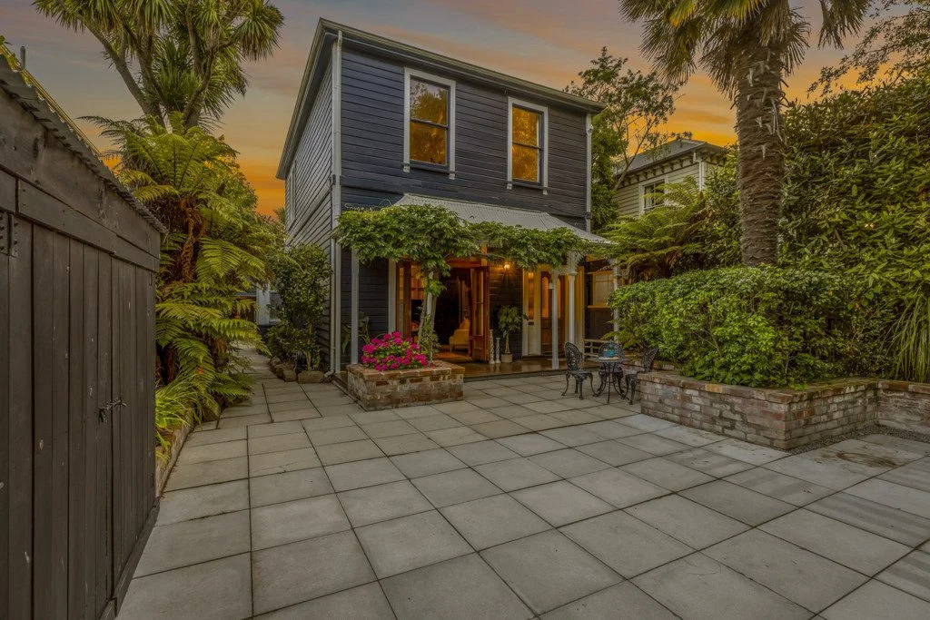 A photo from the courtyard looking up to the grey house.