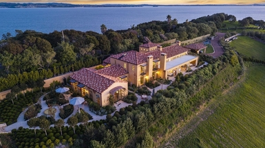 Luxury Mediterranean-style mansion on Waiheke Island, Te Whau Estate, among the most expensive houses in NZ, with terracotta roofs, landscaped gardens, and sweeping views over the Hauraki Gulf.