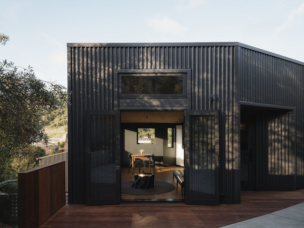 Christchurch architect Braden Harford has just completed a new build right next to his own home in Cashmere - it’s dark inside and out, and he is silencing the critics. Photo: Cowdy