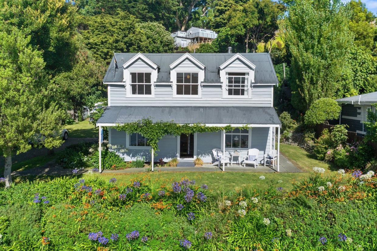 Sitting pretty - this 120m², three-bedroom cottage in Wainui has a stunning view across the Akaroa Harbour. Photo: Bayleys