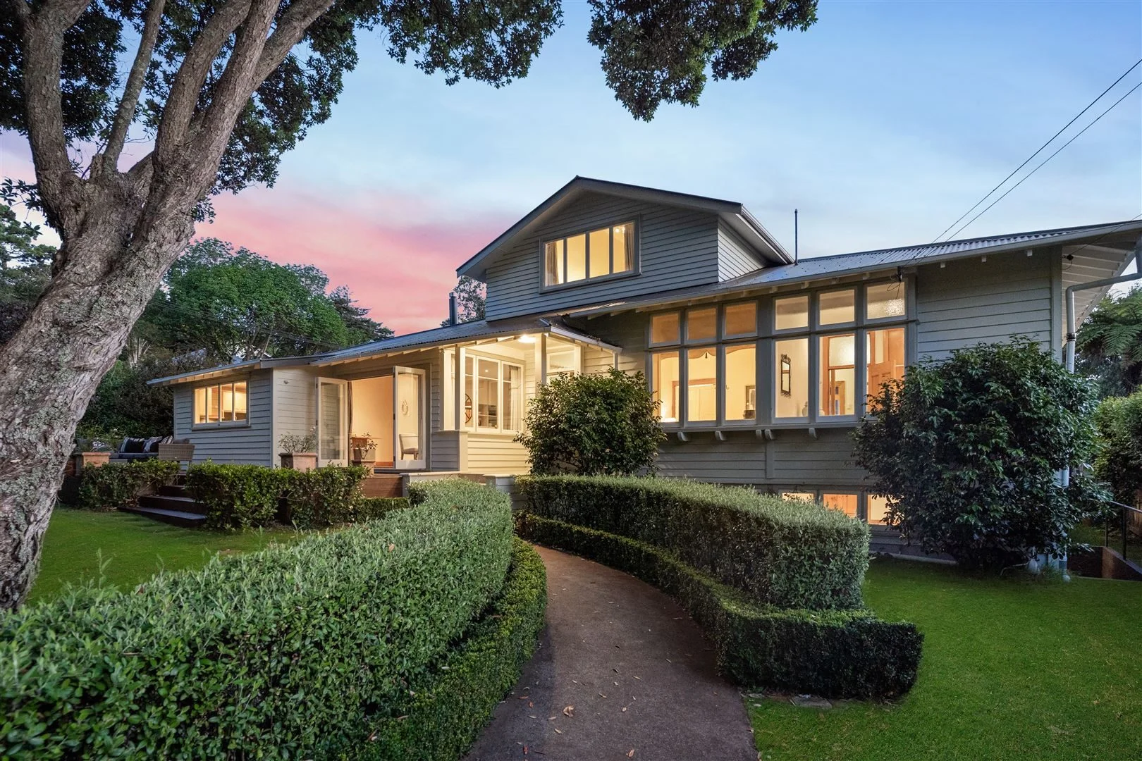 Two storey family home with a sunset in the background
