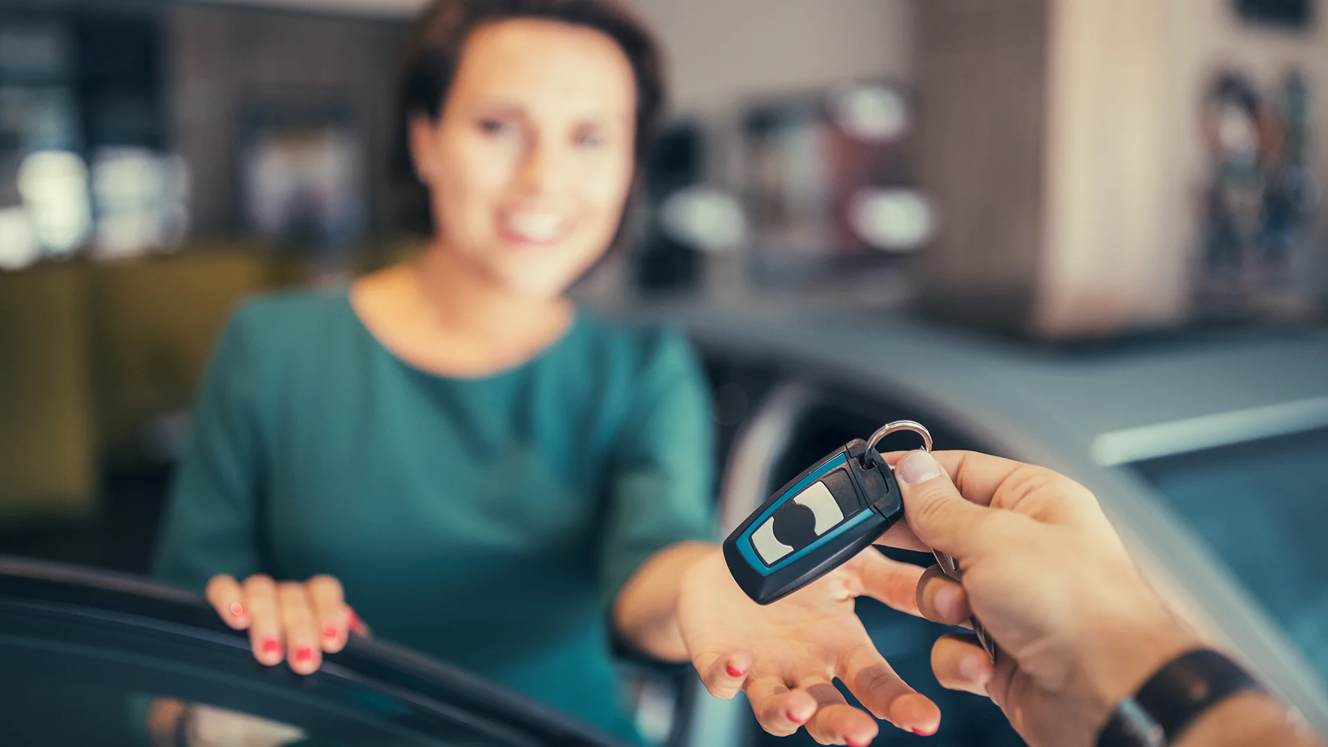 Lady in green top receiving car keys