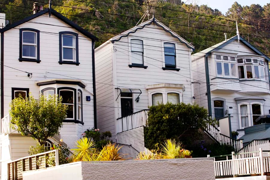 Three white town houses on a hill
