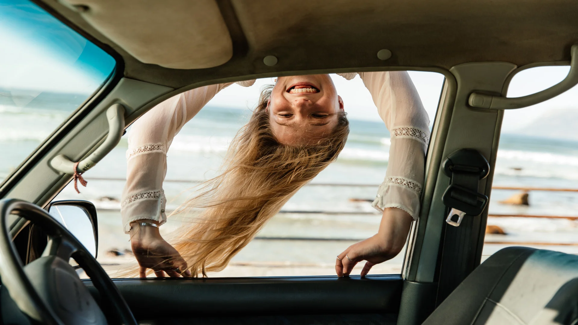 Lady hanging over car window
