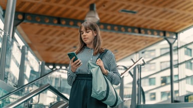 Young businesswoman using phone and Commuting in bus stop