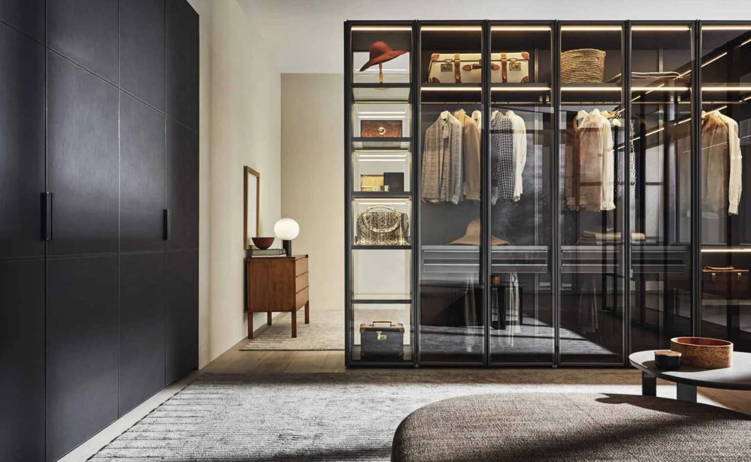 A modern bedroom featuring a see-through wardrobe that effectively breaks up the space, adding style and functionality to the room.
