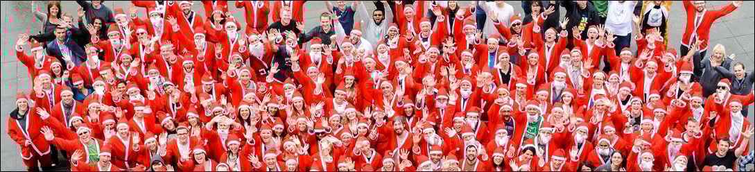 A sea of Trade Me staff wearing red and white santa suits, viewed from above