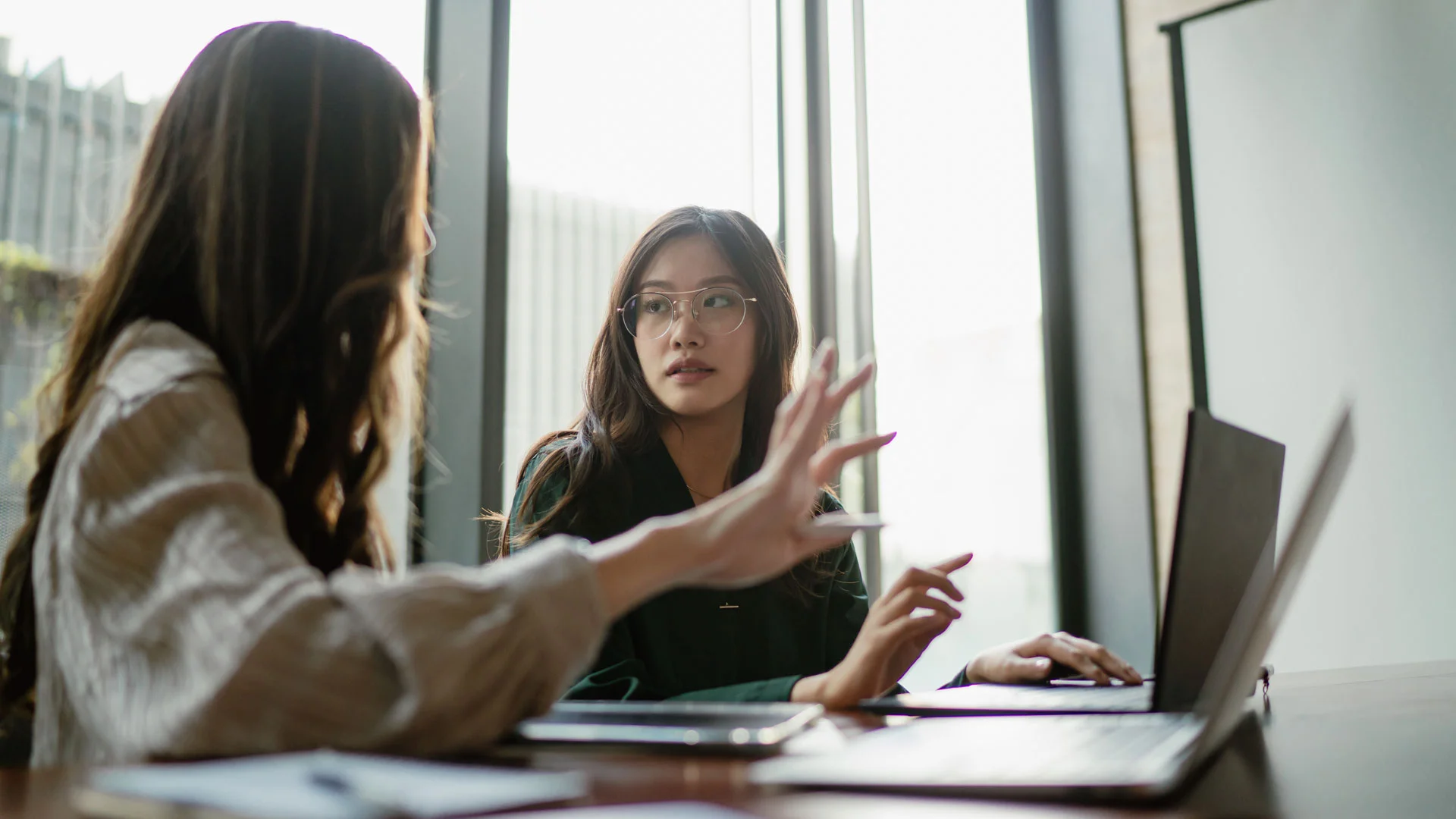 Two colleagues talking about the salaries at work.