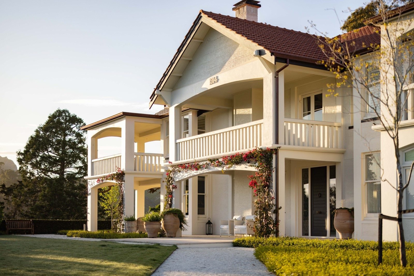 Heritage-style two-storey home with verandahs, bougainvillea and manicured gardens at 152 Kopanga Road, Havelock North