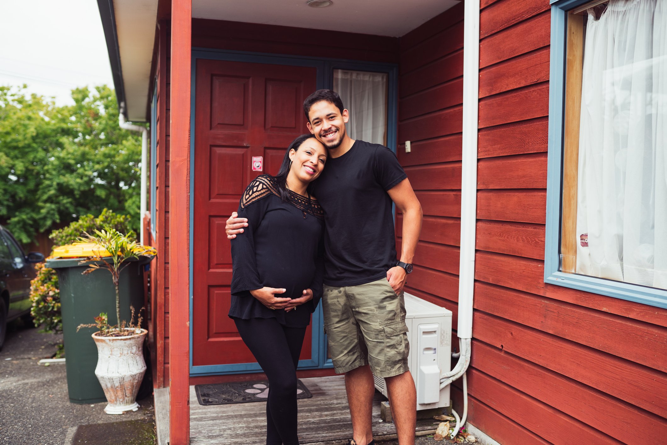 Couple outside their first home in Auckland