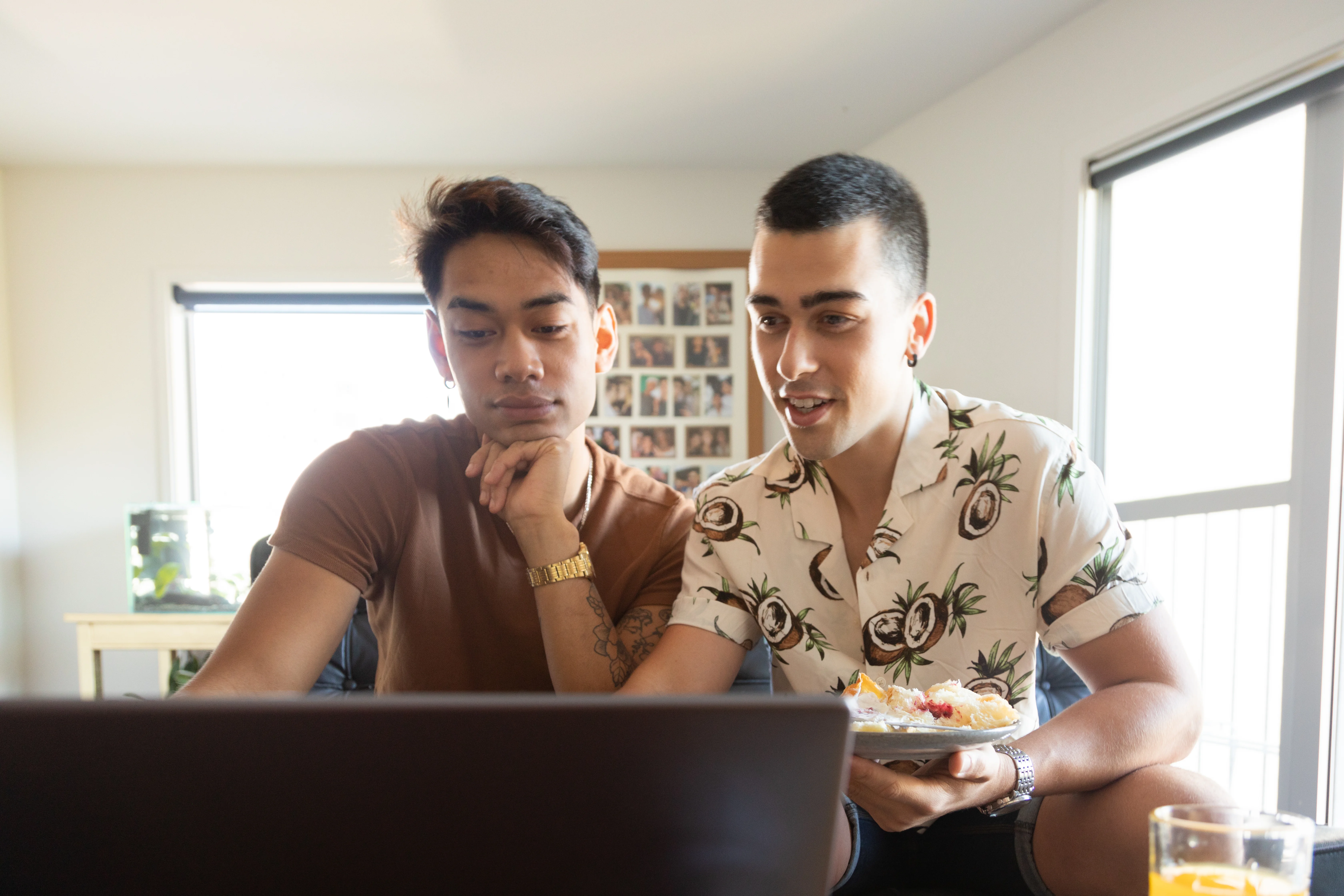 A couple at home looking at a laptop together.
