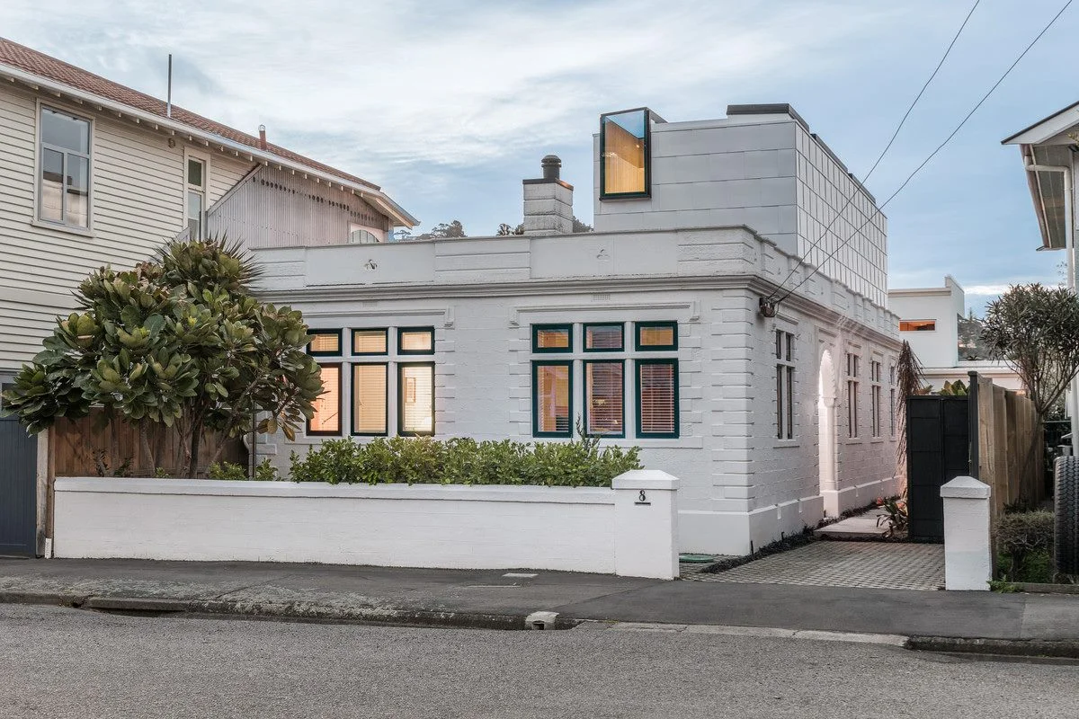 White brick house with a flat roof and large windows