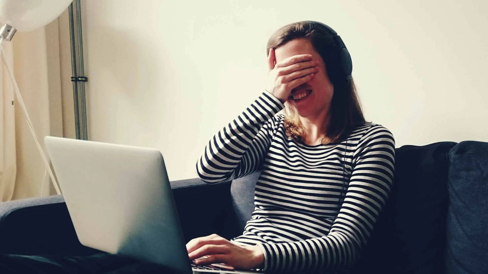 Candidate laughing at her laptop.