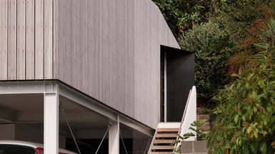 Front view of the home with the architectural features including the steel portal frames.