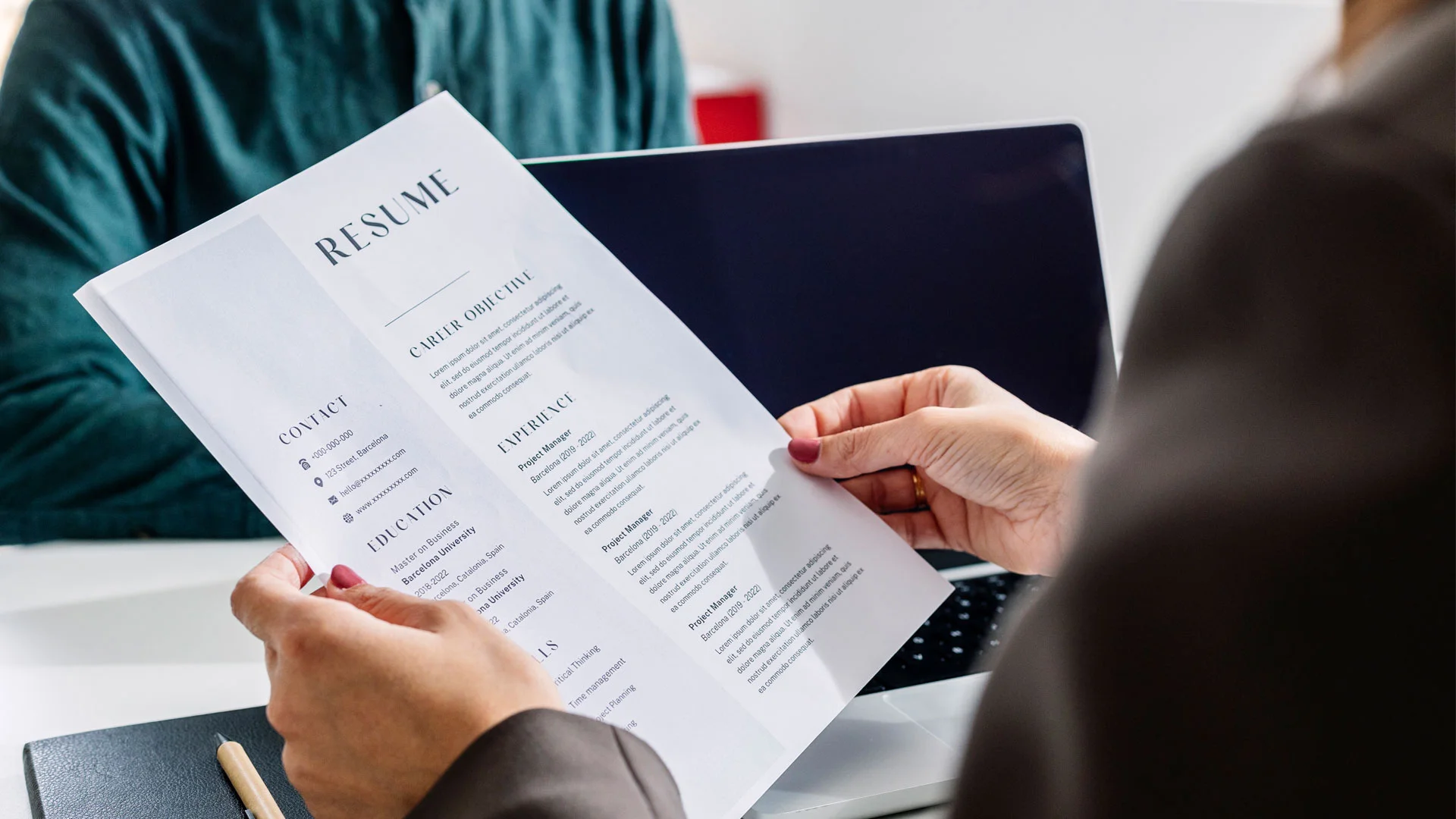 Hiring manager holding a resume. 