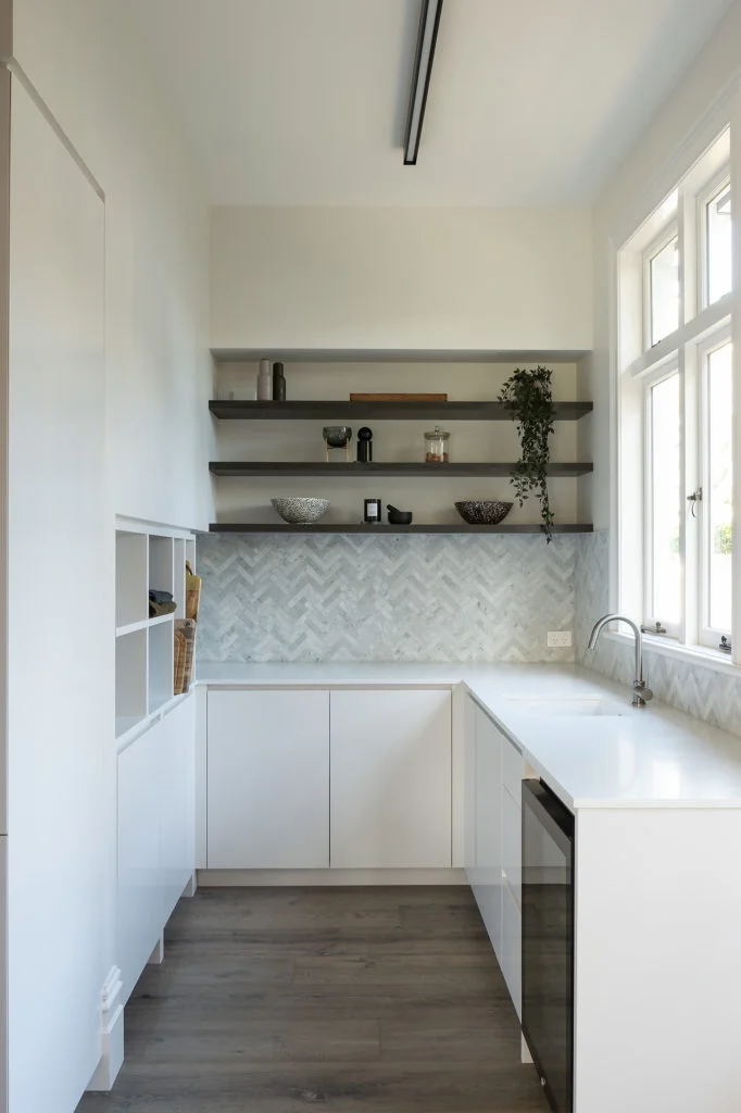 White galley scullery with oak floors