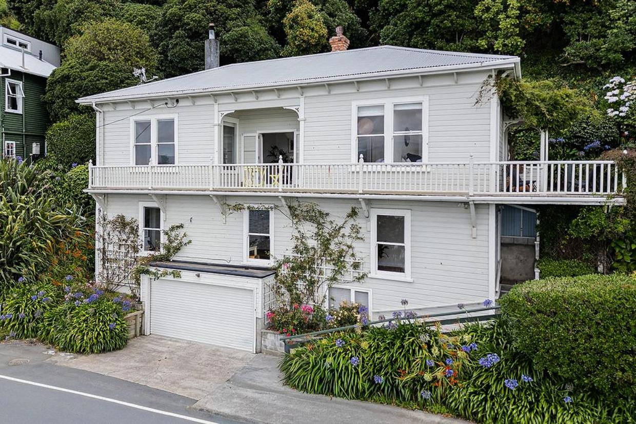 Built around 1900, this Karaka Bays house remains a solid, spacious waterfront home with uninterrupted views across Wellington Harbour