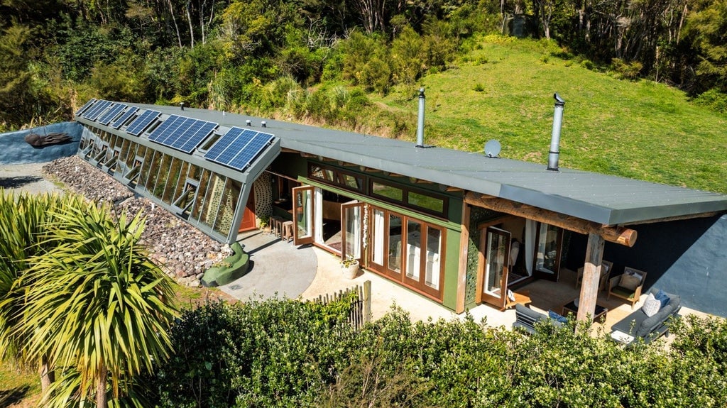 Coromandel’s sole Earthship house in Hikuai has come to market for the first time. Te Timatanga was built in 2015 by Sarah Rowe and Gus Anning. They are pictured with the children during the build. From left, Leo Anning, Gus, Sarah, Toby McNabb, Bryony McNabb. Photo: Pete May
