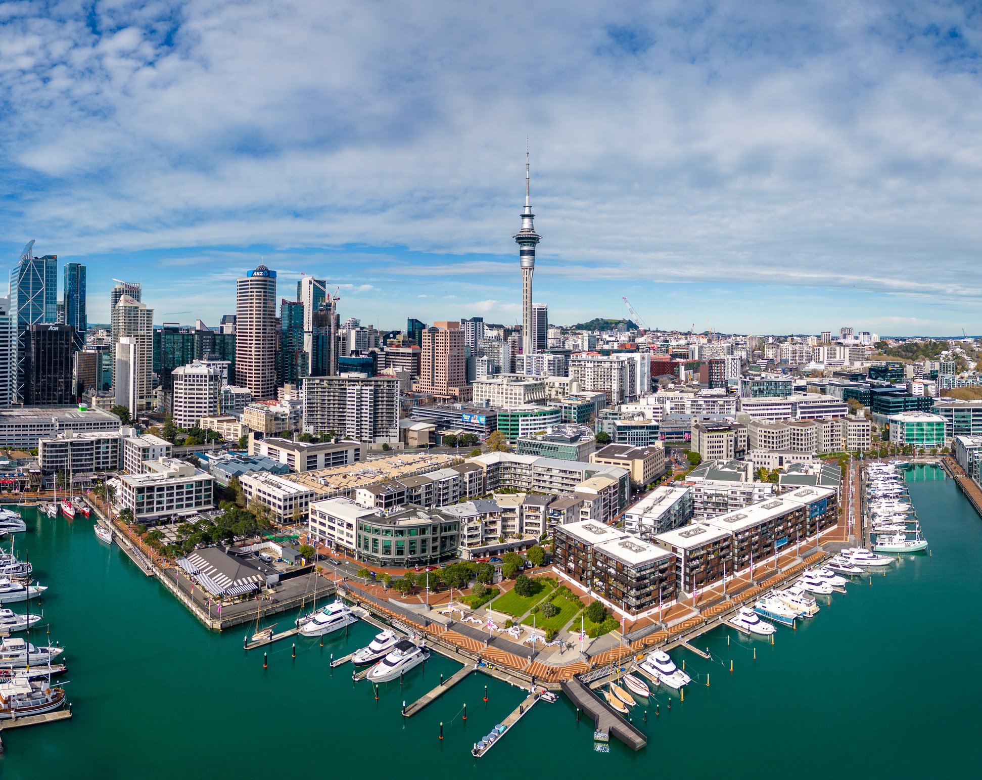 Aerial view of Auckland Viaduct Harbour with its yachts and sailboats marina and luxury modern residential real estate and the city skyline of the downtown district in New Zealand largest city