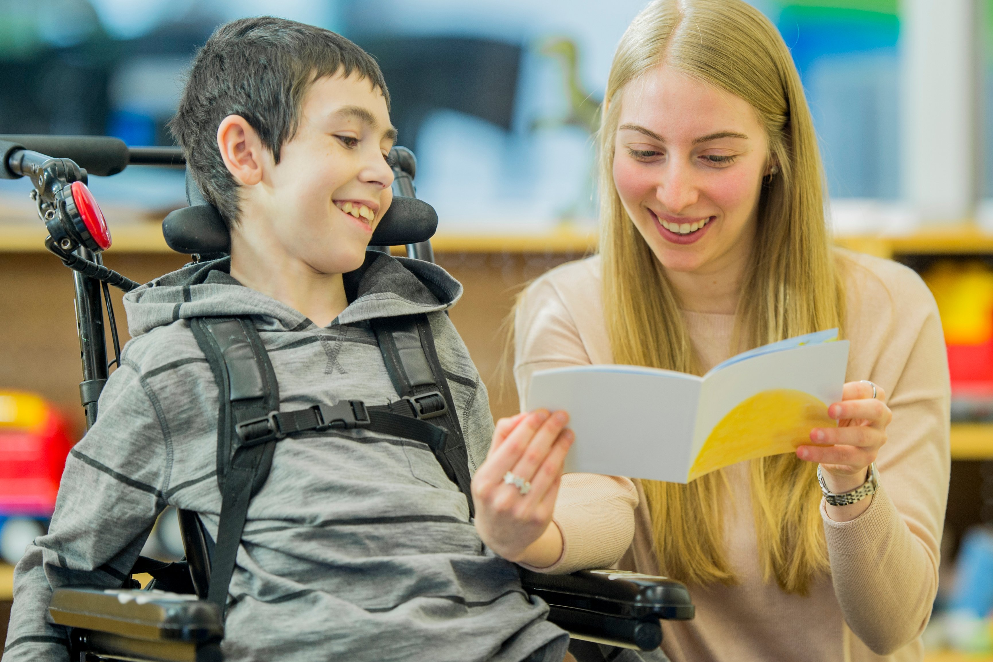 Teacher aide helping her student
