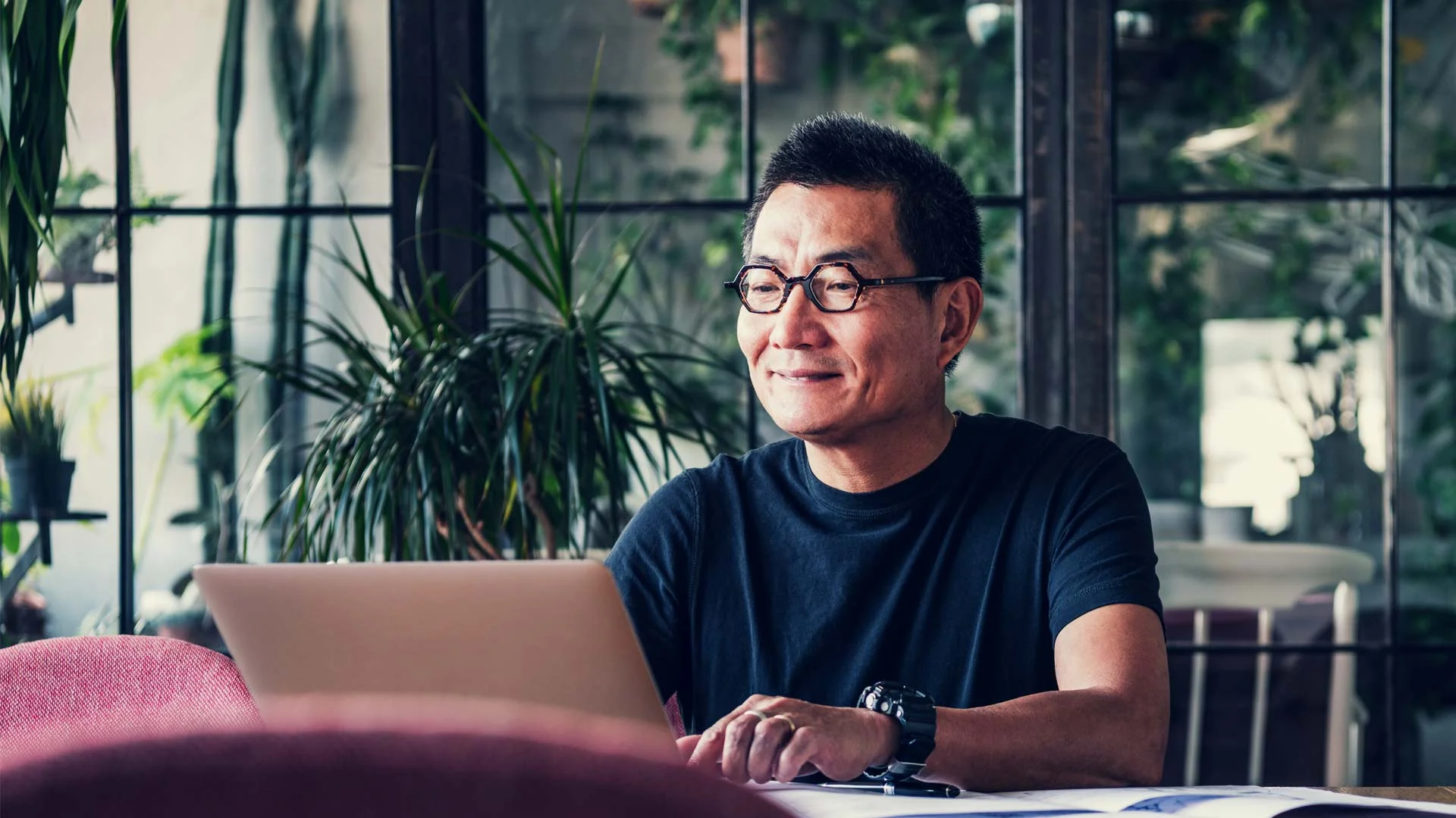 A man sitting at a desk with his laptop creating a listing so he can sell items on Trade Me.