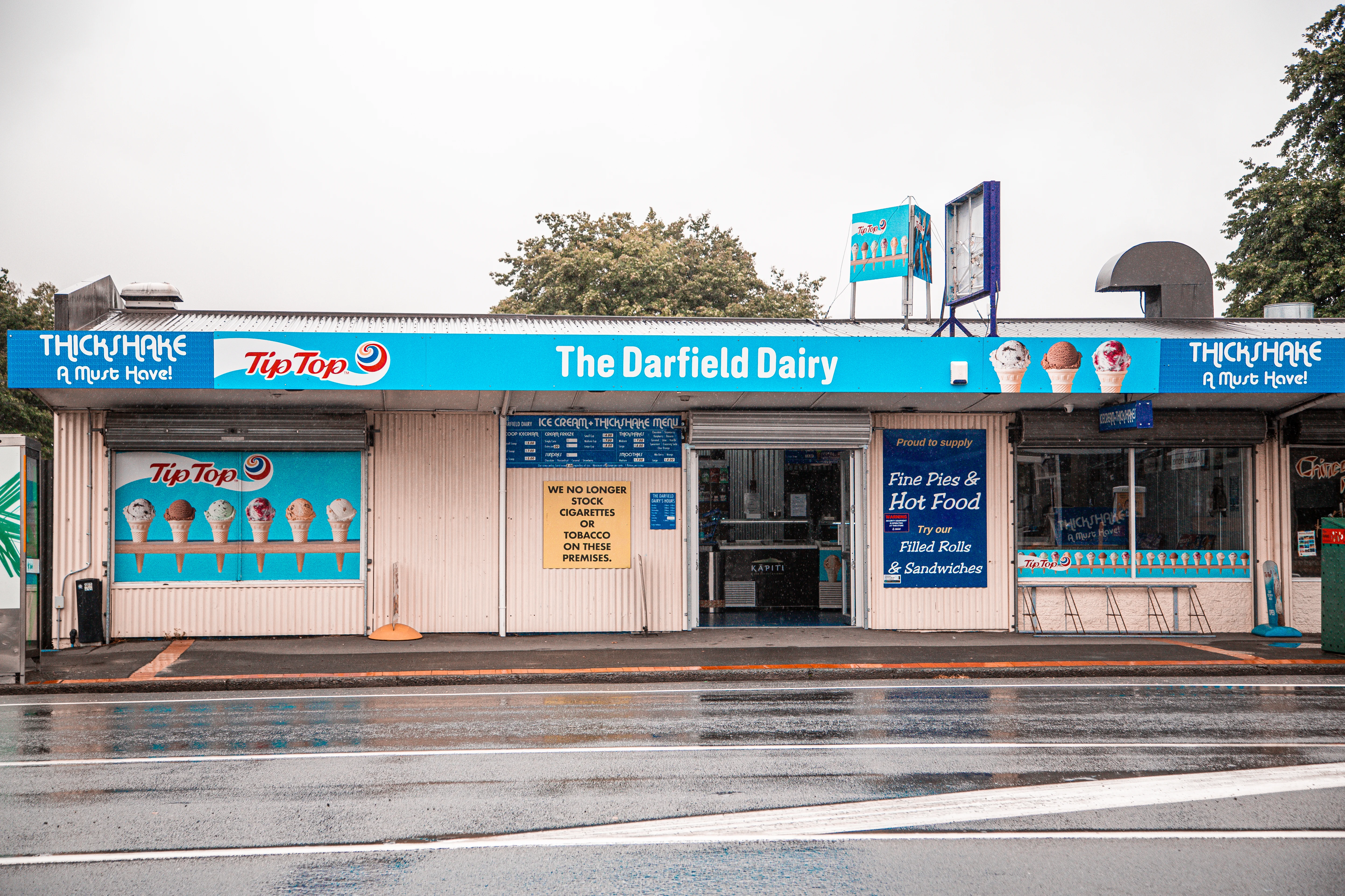 Blue and white shop front with a header that says Darfield Dairy.