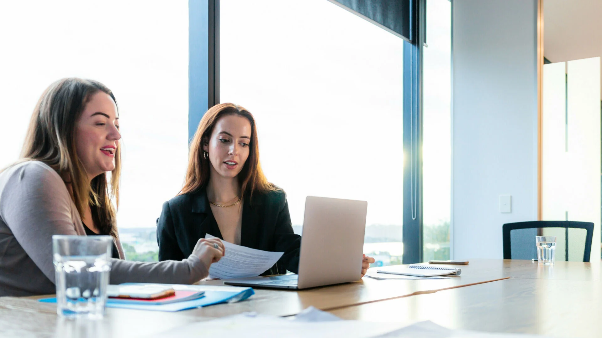 Manager and reportee discussing resignation in a meeting room.