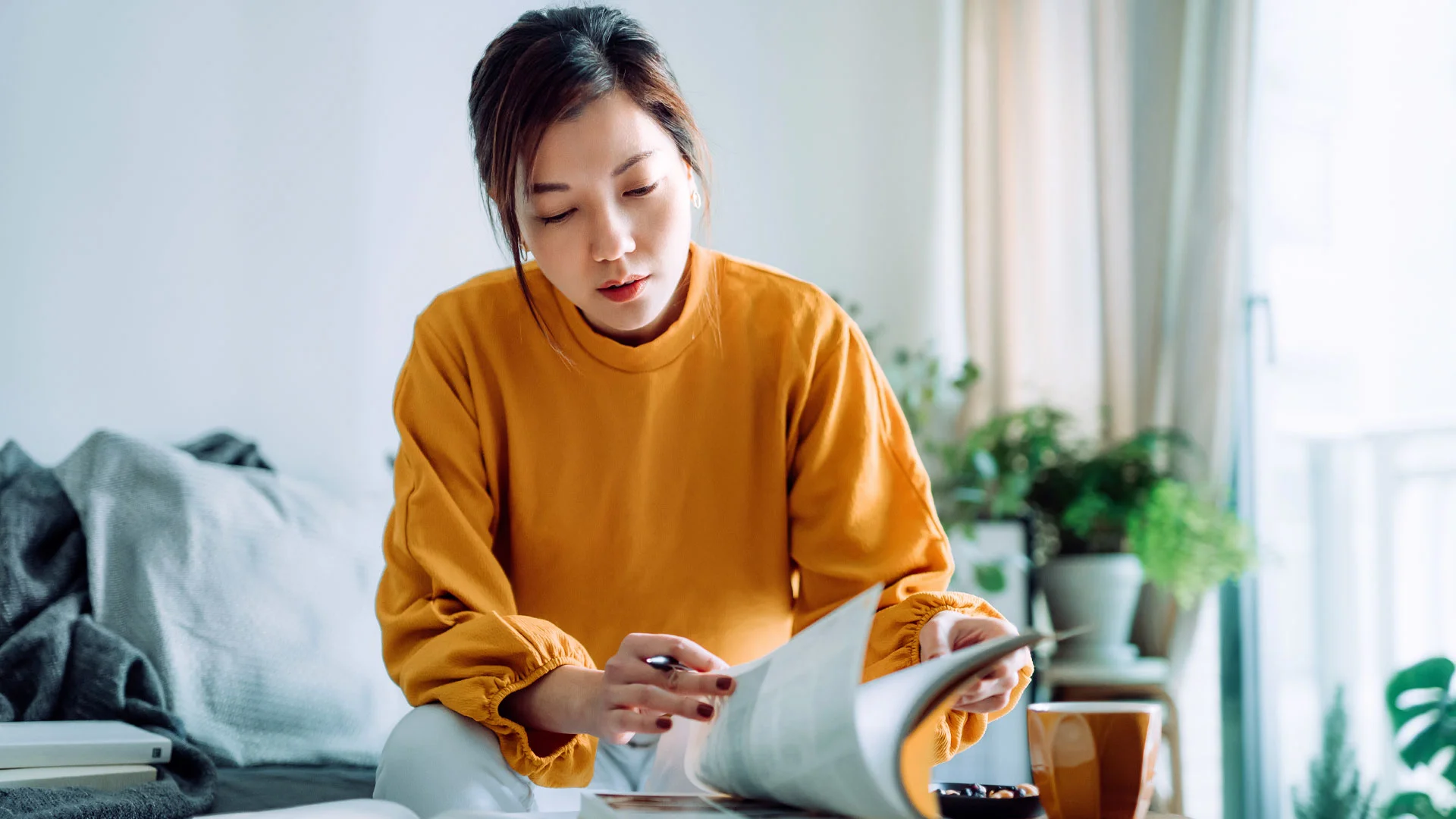 Law student working through a text book at home.