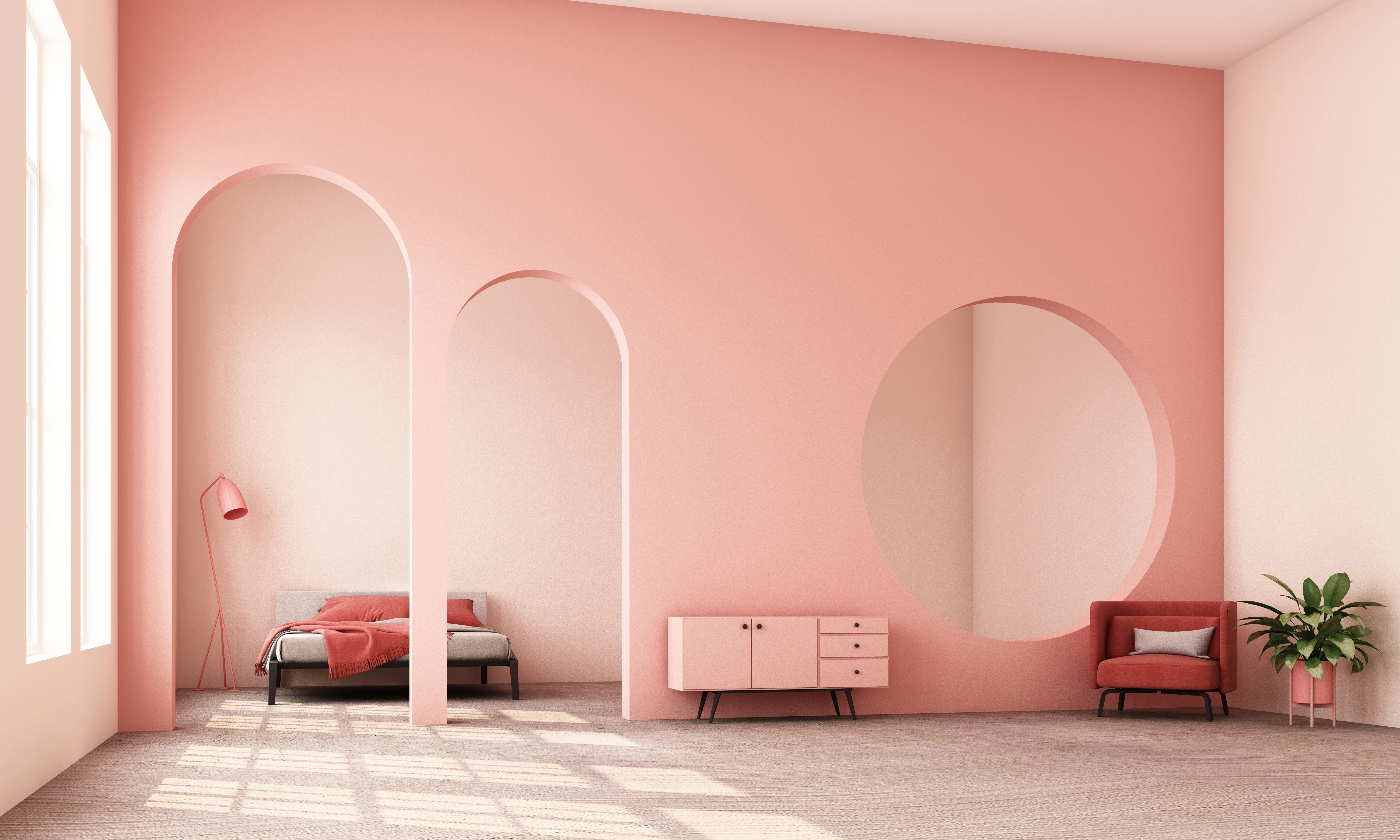 A large room with a pink wall with three curved feature doorways.