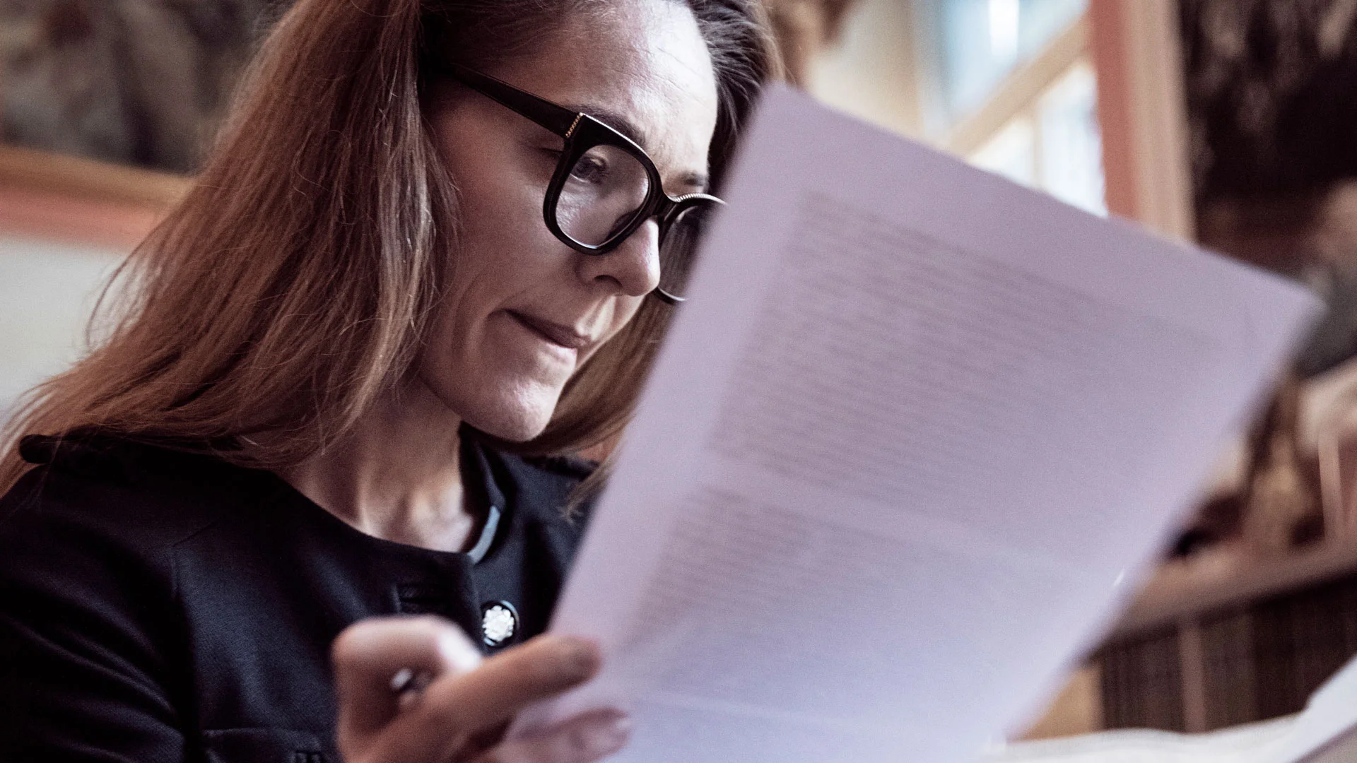 DOC policy analyst reviewing documents.